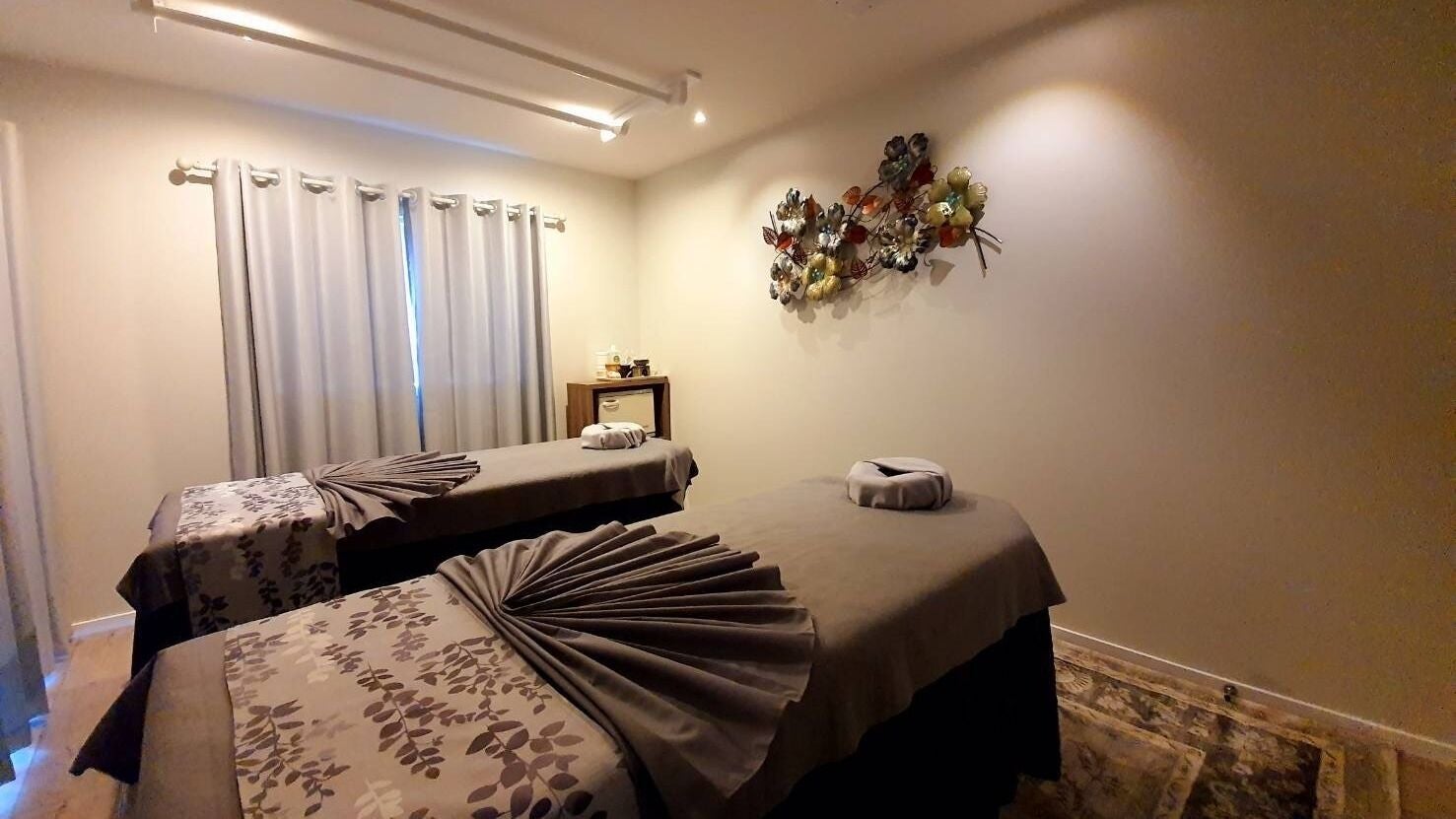 Relaxing massage room at Siwalai Thai Massage and Spa, Auckland, NZ featuring two massage tables with elegant decor.