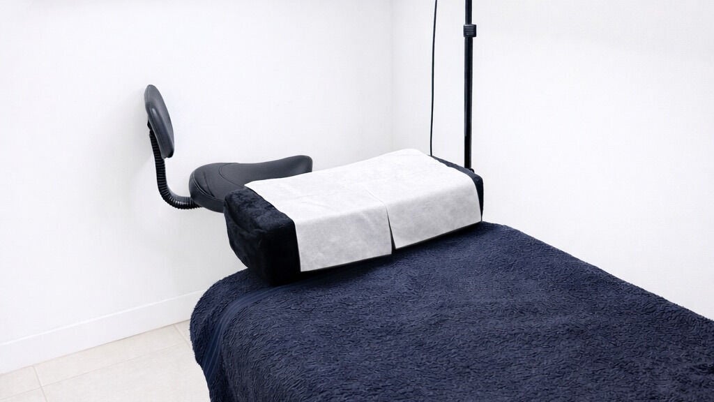 Cozy massage bed at SheLacque, Melbourne, Victoria, AU, offering soothing wellness treatments in a tranquil setting.
