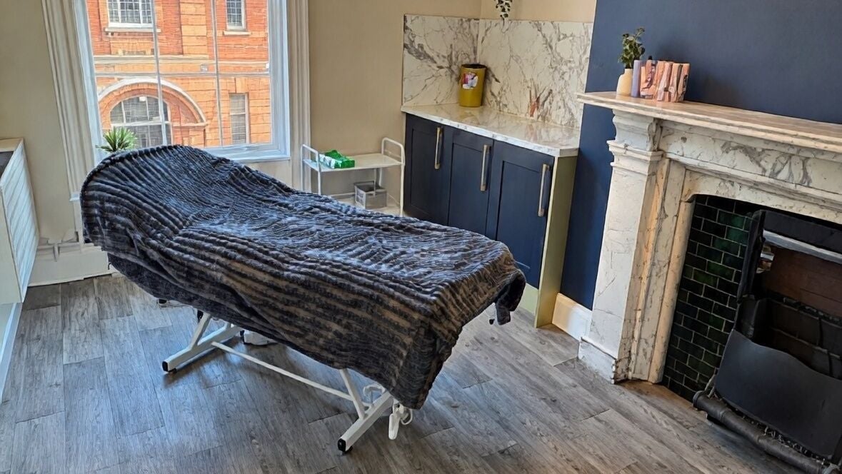 Relaxing therapy room at Essence Of Eb., Carlisle, England, GB featuring a plush treatment bed and elegant decor.