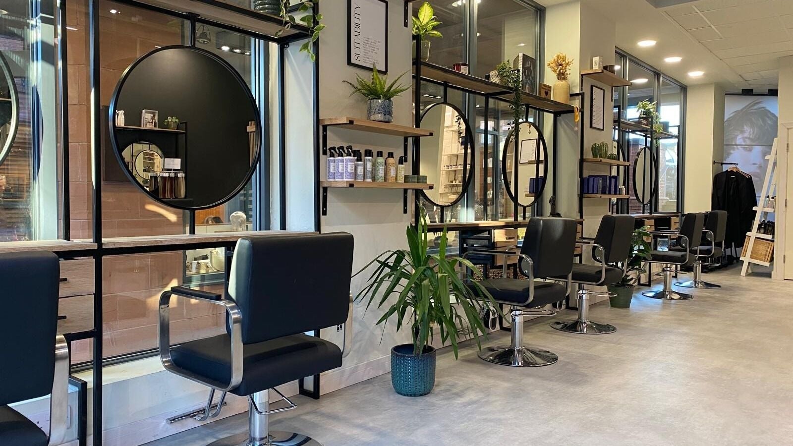Elegant interior of Benny & Co. Hair Studios, Knutsford, England, GB featuring stylish decor and seating.