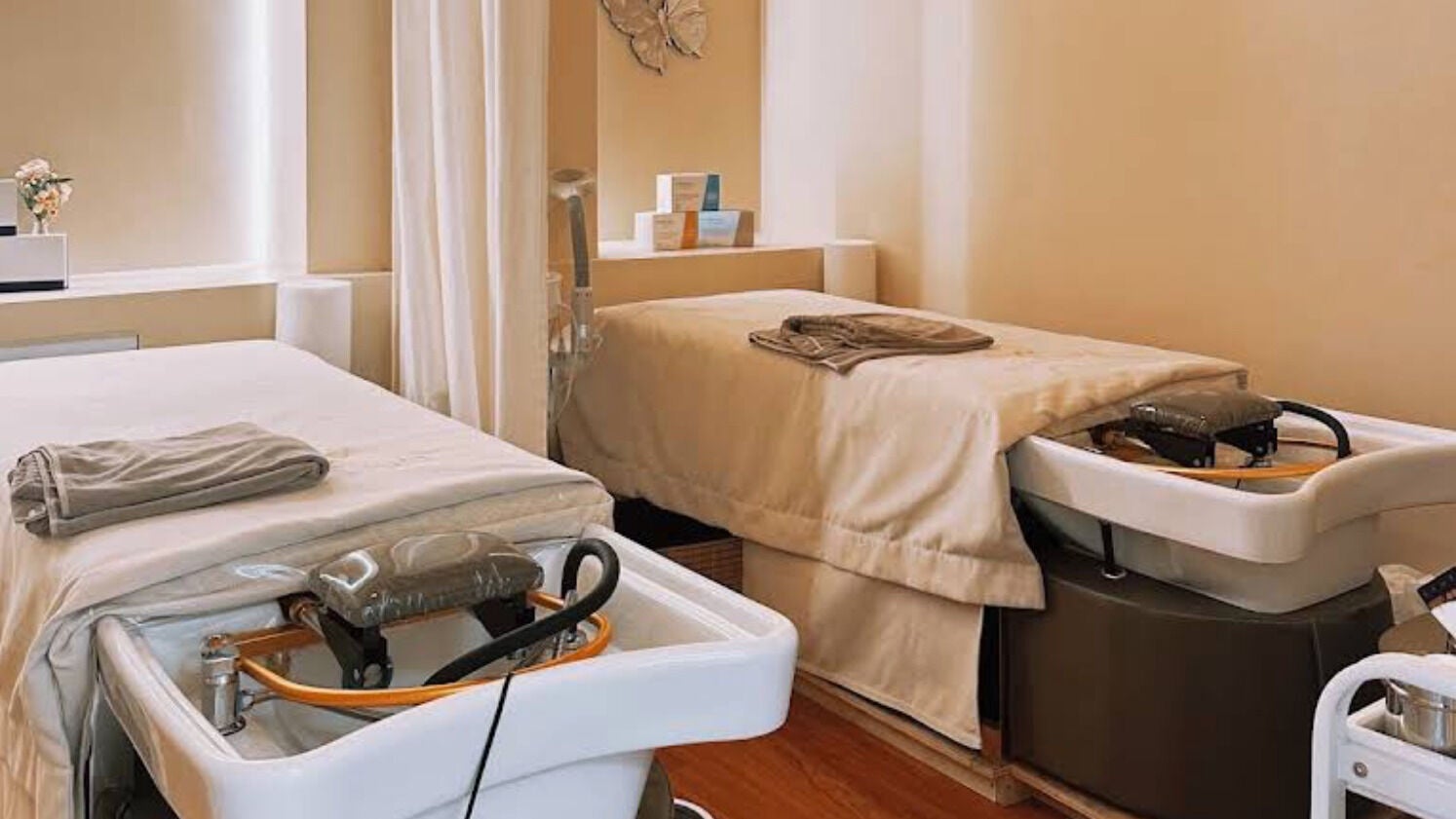 Relaxing spa treatment room at SENA, New York, New York, US, featuring cozy massage tables and elegant decor.