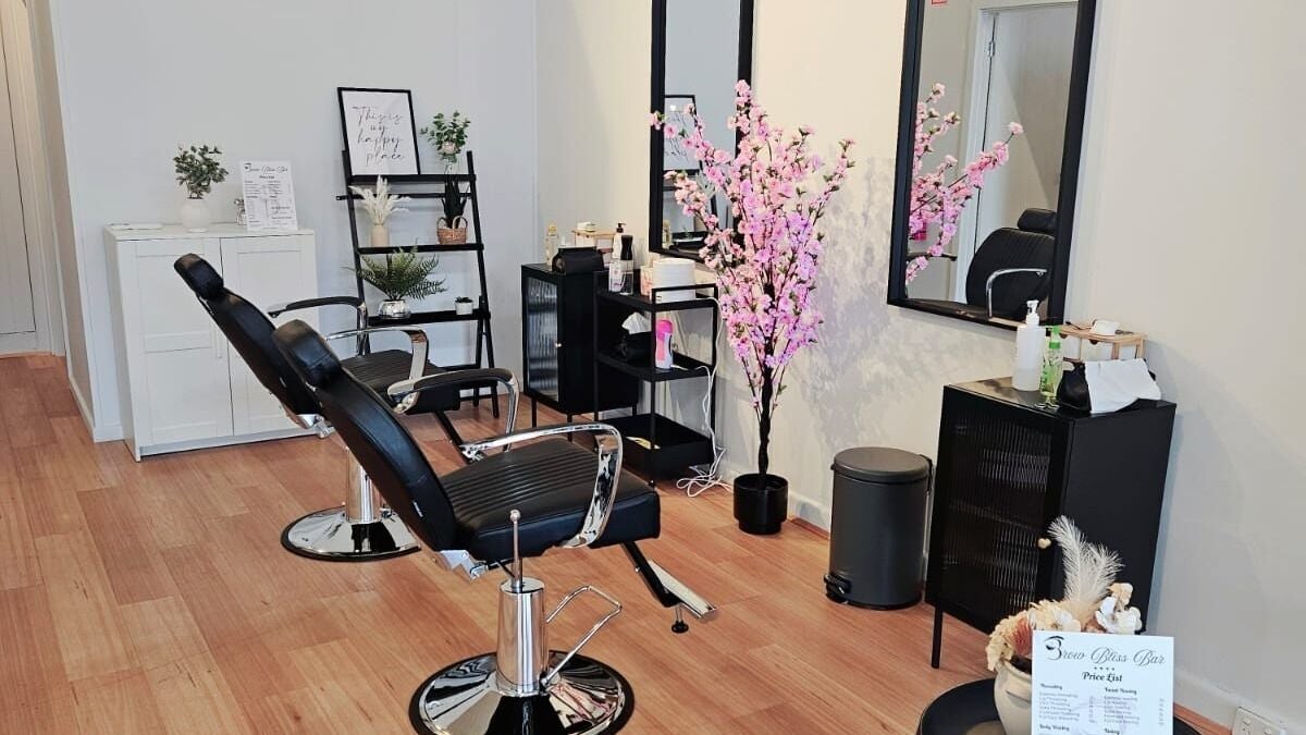 Modern salon interior at Brow Bliss Bar, Malvern, Victoria, AU with sleek chairs and elegant decor.