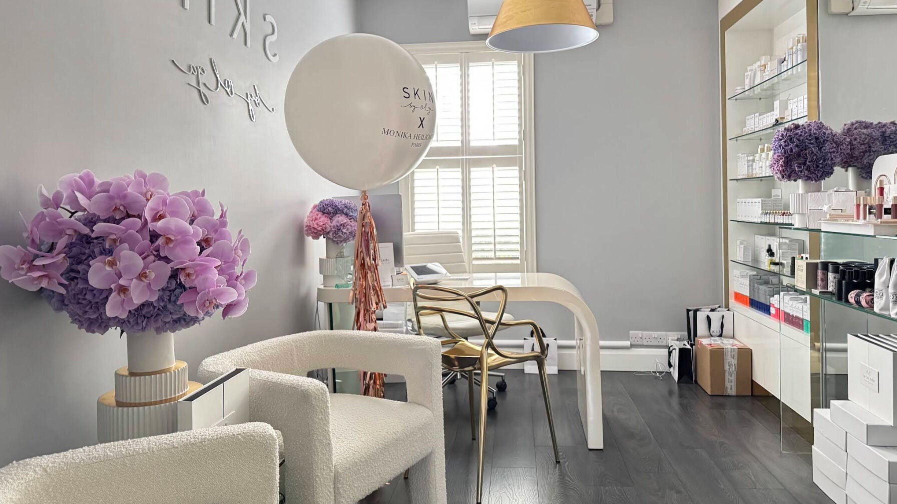 Luxurious treatment room at Skin By Olga, Dublin, County Dublin, IE featuring plush seating and floral decor.