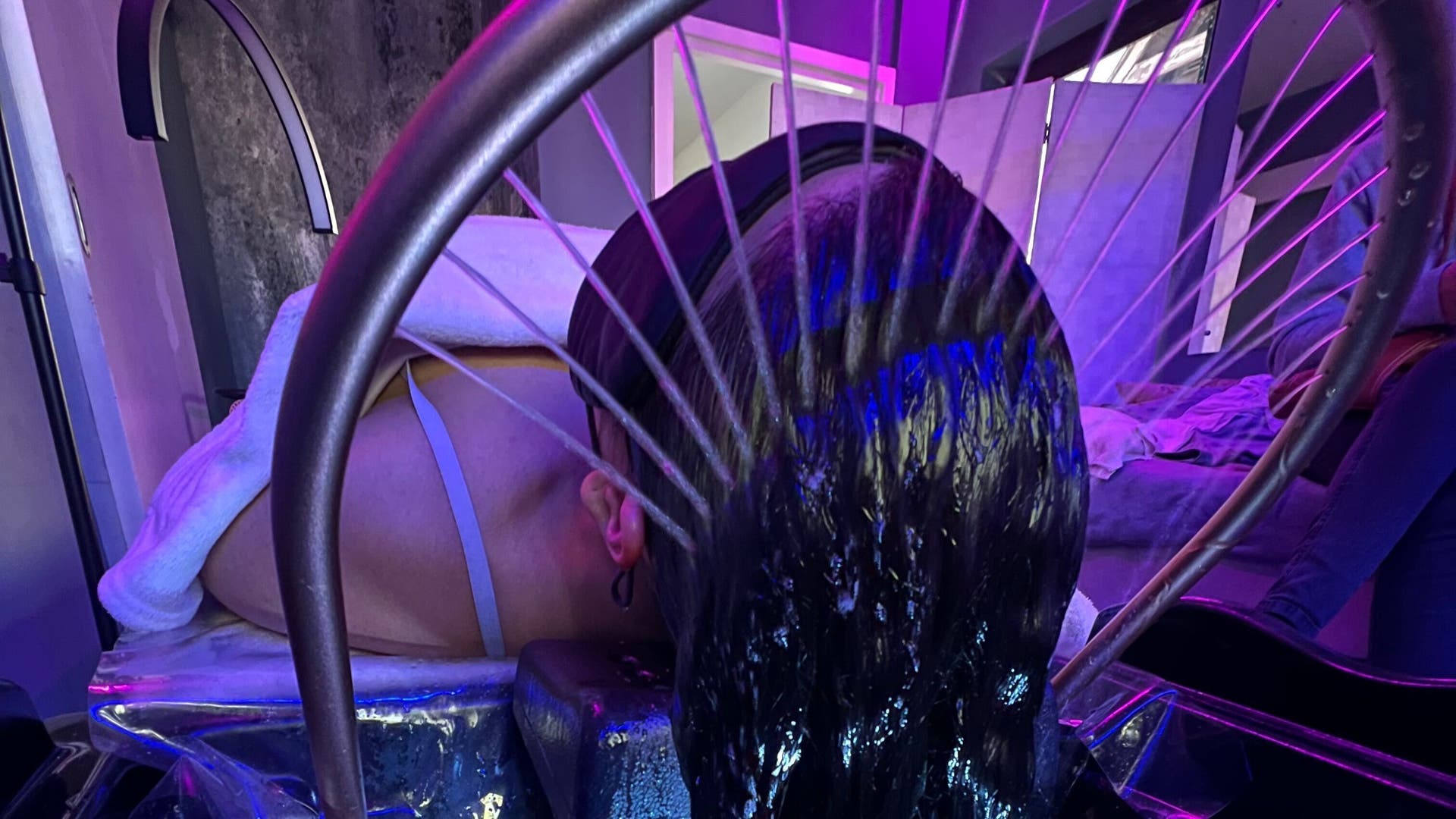 A relaxing hydrotherapy treatment at CC Euphoria, Cape Town, ZA with water gently cascading on a client's head.