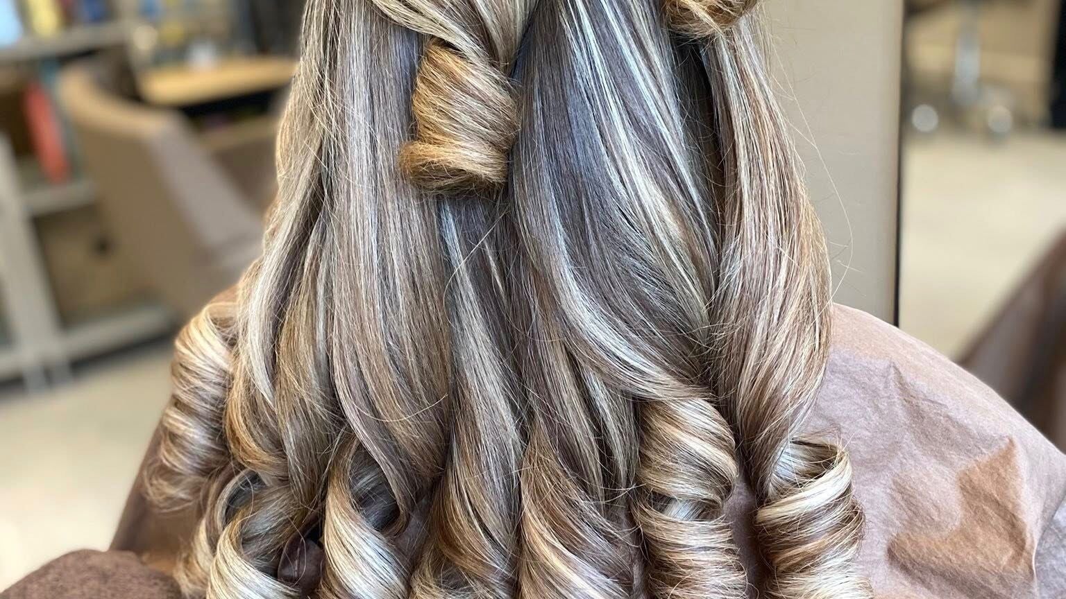 Stylish curled hairstyle at CMW Elite Hair, Greenock, Scotland, GB. Perfectly styled for a glamorous look.