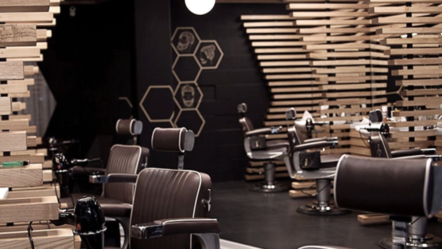 Stylish interior of ADAM Grooming Atelier - Fitzrovia with modern barber chairs in London, England, GB.