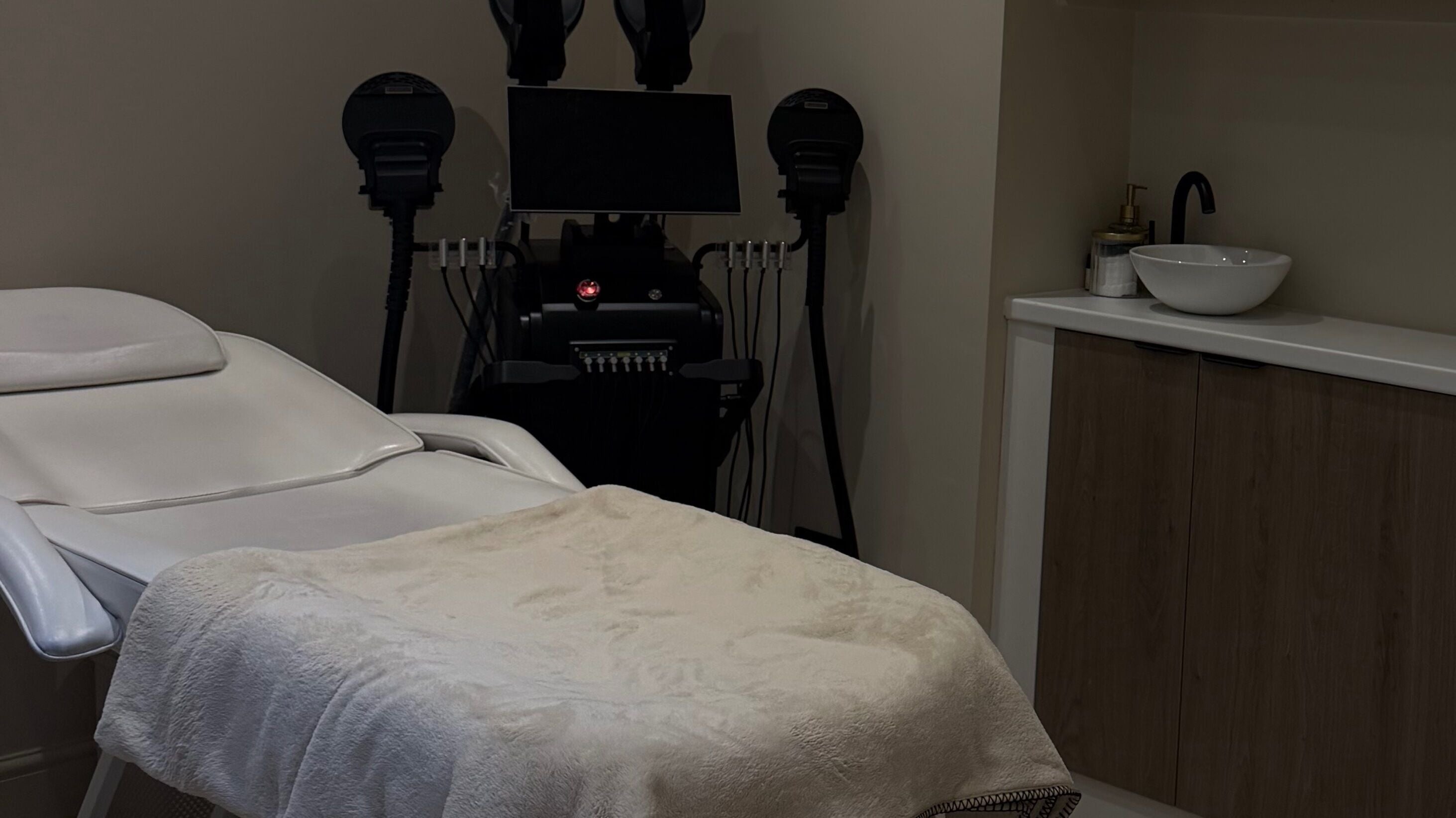 Elegant treatment room at Sculpted by Ashleigh, Wallasey, England, GB showcasing a luxurious spa bed and equipment.
