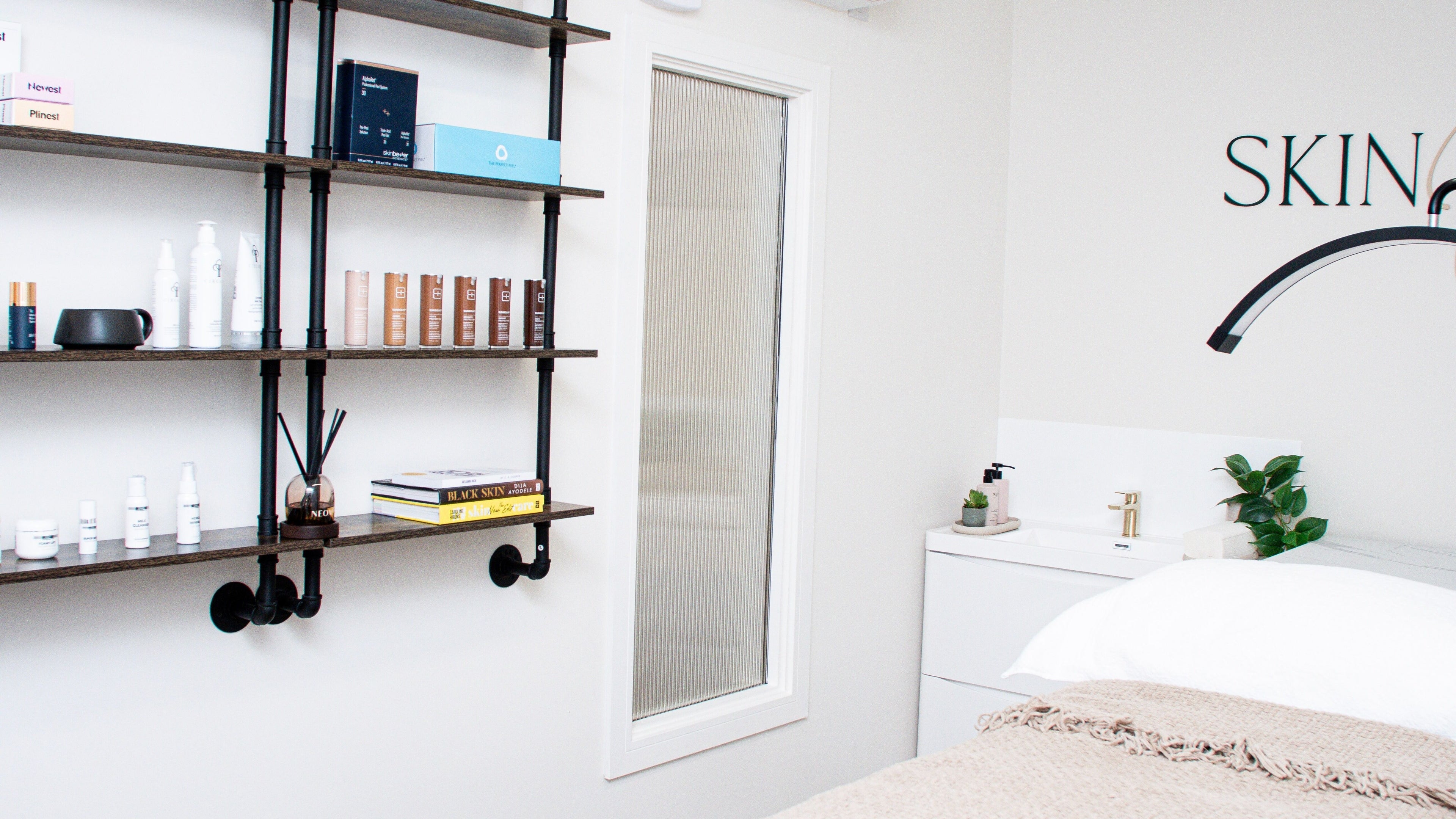 Elegant treatment room at Skin Orchid, London, England, GB, featuring skincare products and a cozy ambiance.