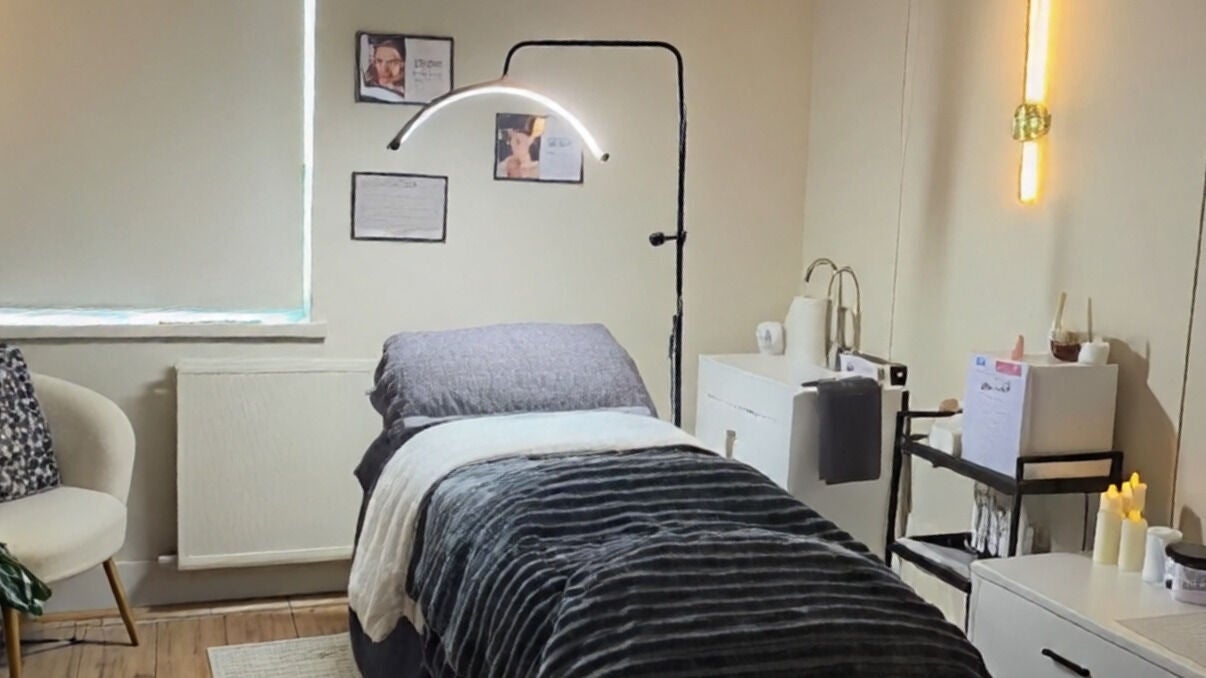 Relaxing spa room at At Your Fingertips in Blantyre, Scotland, GB with cozy treatment bed and soft lighting.