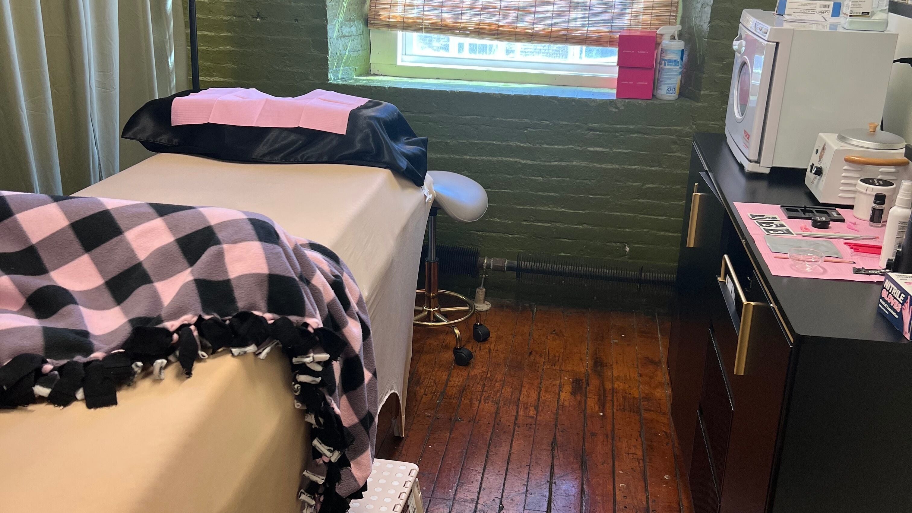 Relaxing treatment room at Rosy Cheeks Beauty Studio, Biddeford, Maine, US with bed and spa equipment.