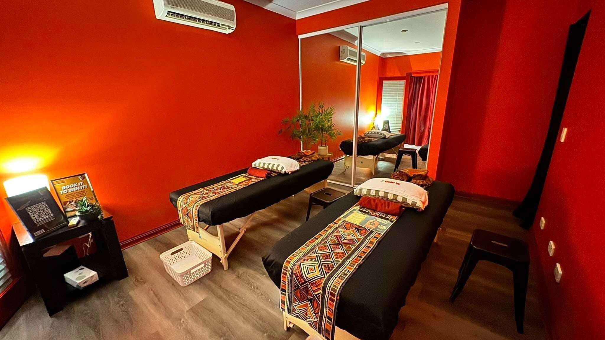 Relaxing massage room at Bamboo Spa Pascoe Vale in Melbourne, Victoria, AU, featuring vibrant decor and twin tables.