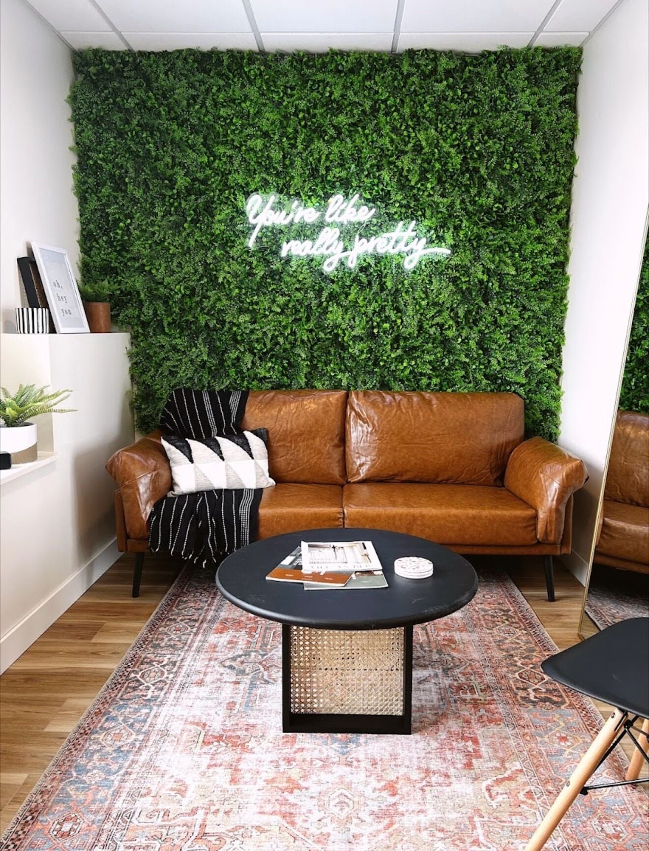Cozy brown leather sofa with greenery at Sol Aesthetics-Hastings, Hastings, Minnesota, US.