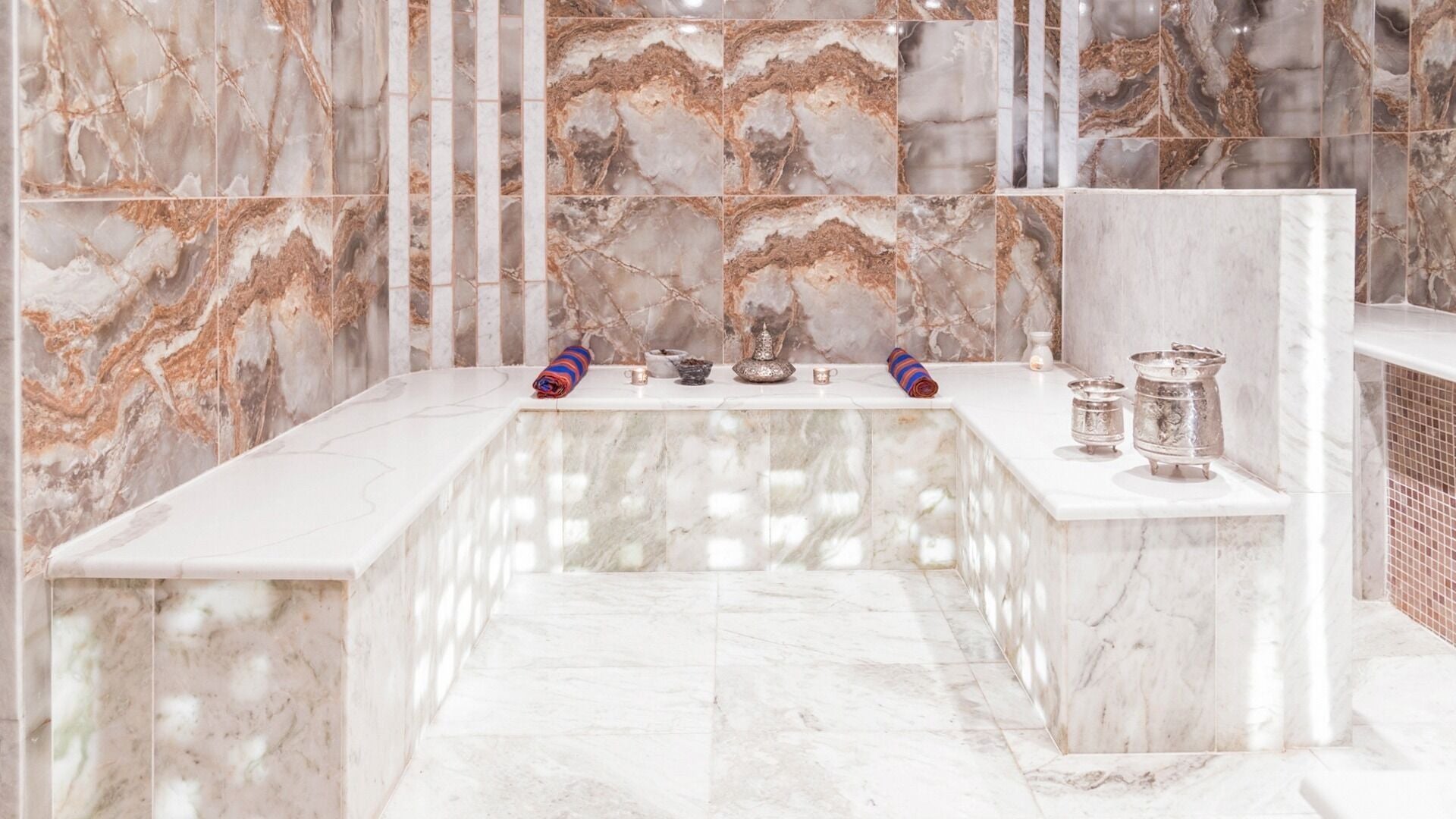 Luxurious marble spa room at Casa Spa in London, England, GB, showcasing plush towels and elegant decor.
