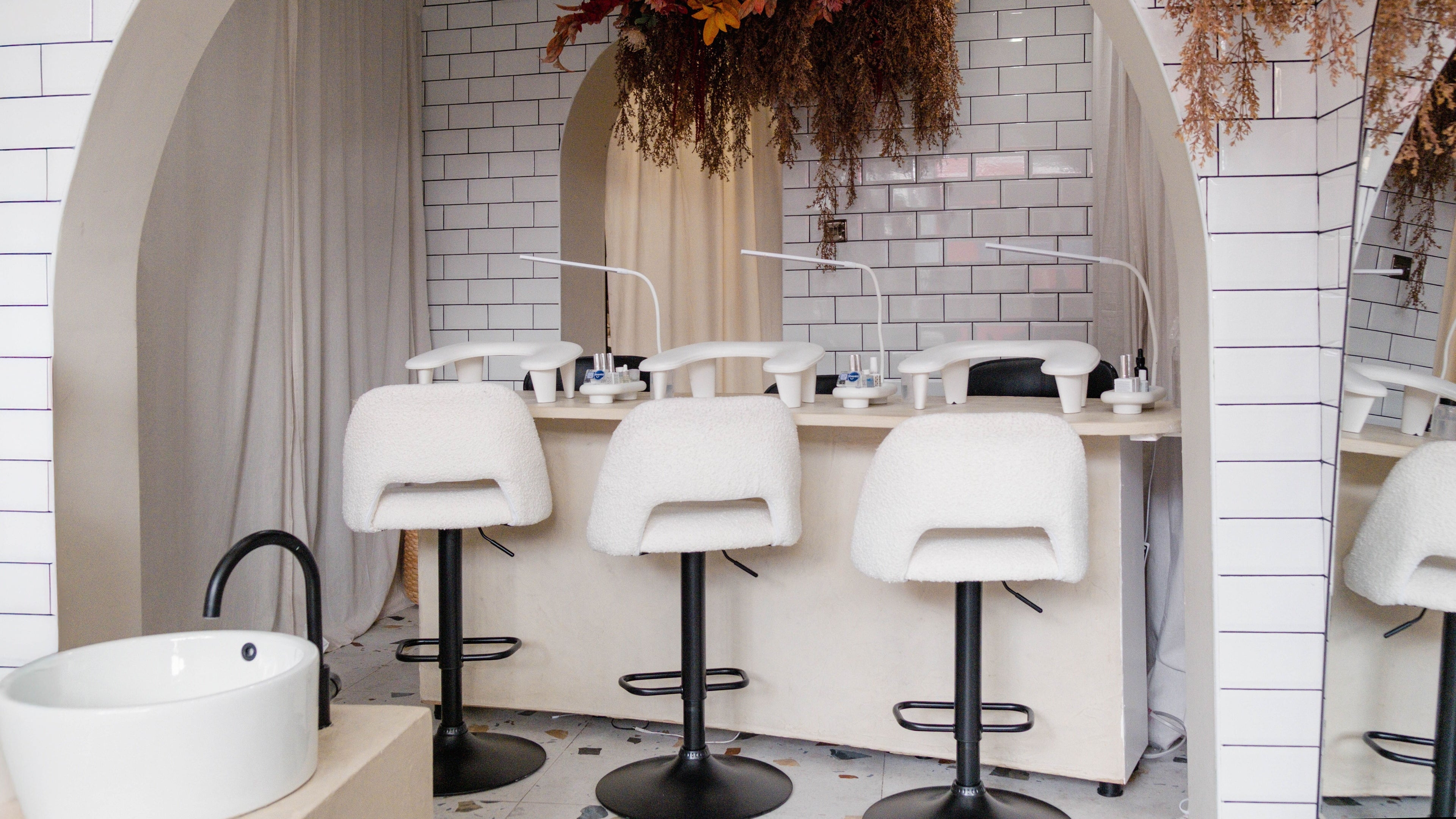Chic manicure station at Awe London Shoreditch, London, England, GB with modern decor and plush seating.
