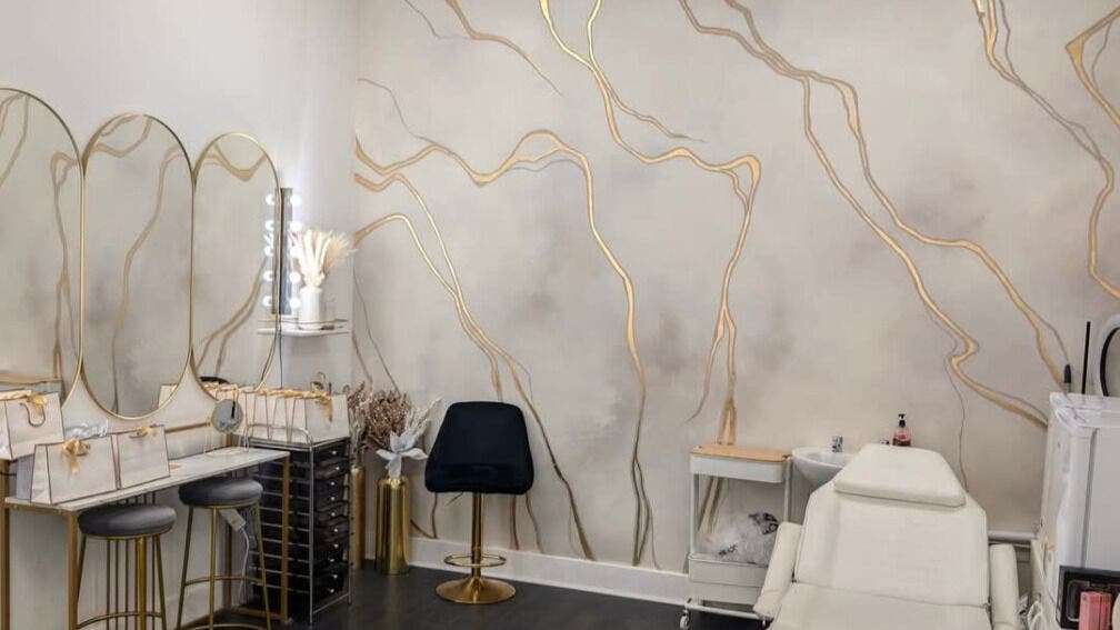 Beautiful interior of CJays Make-up Academy, Glasgow, Scotland, GB with gold-accented mirrors and chic seating.