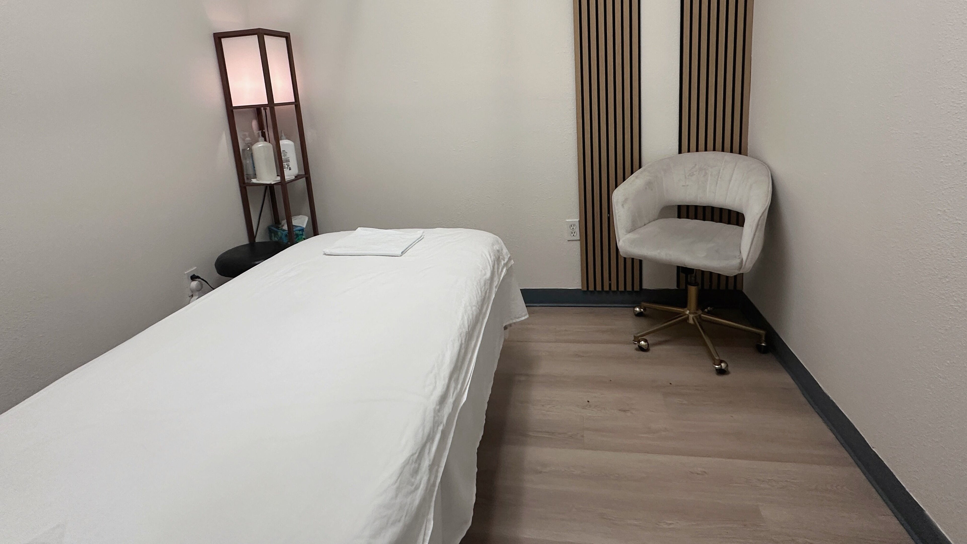 Tranquil treatment room at Elite Spa, Winter Springs, Florida, US, featuring a massage bed and elegant decor.