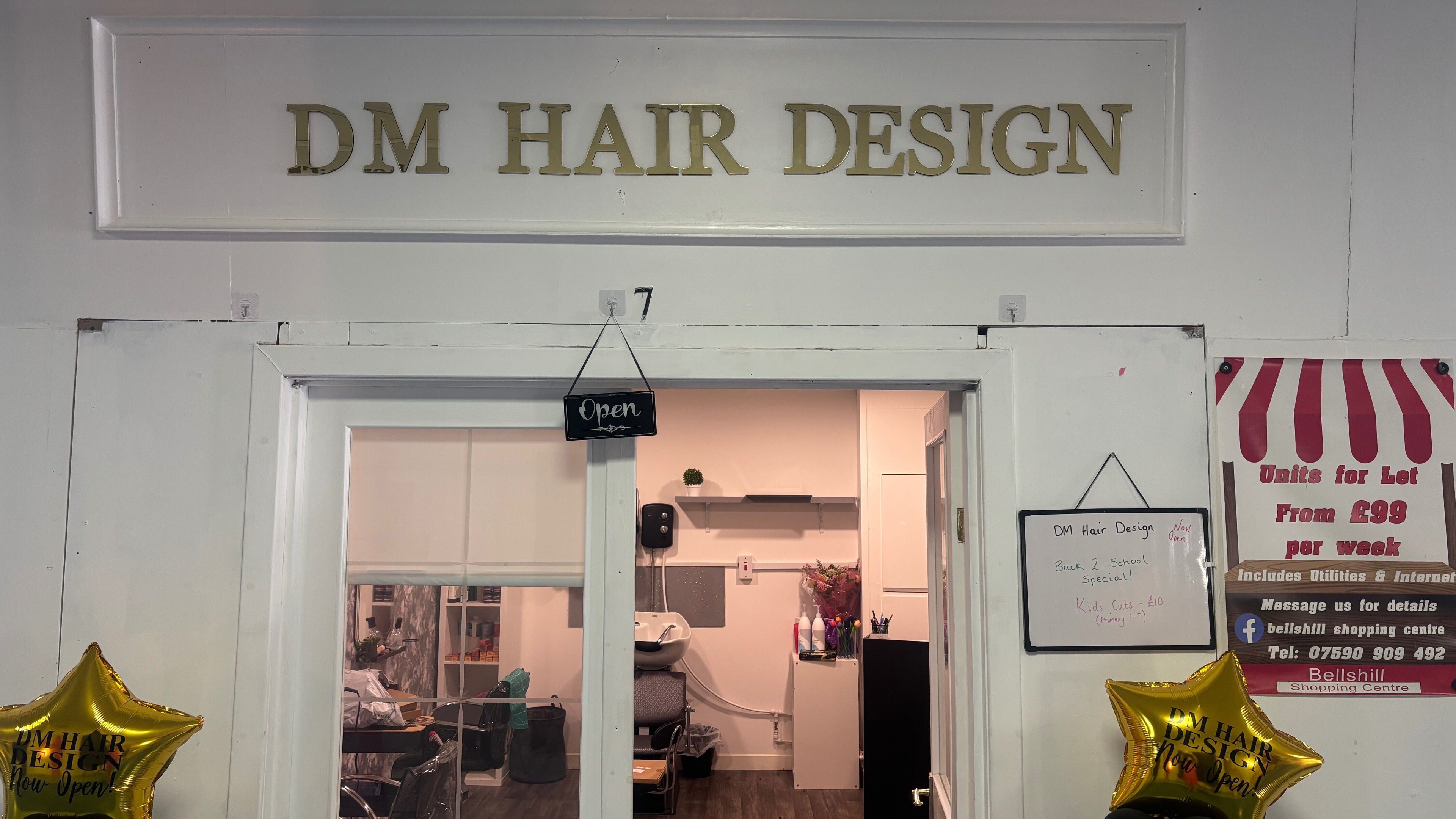 Exterior view of DM Hair Design with open sign at Bellshill, Scotland, GB.