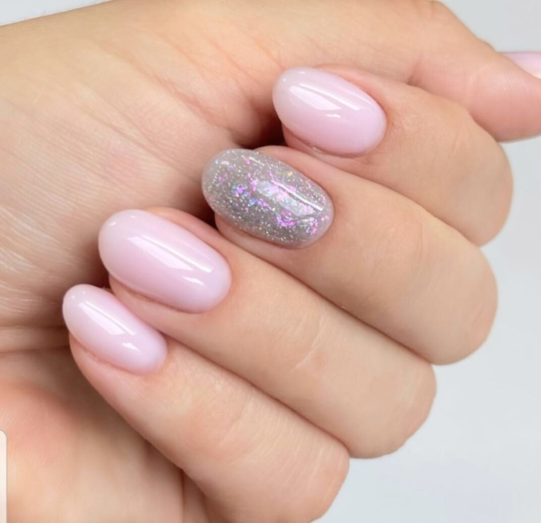 Elegant manicured hand with pink and glitter nail polish at H&B Nail Lab, Melbourne, Victoria, AU.