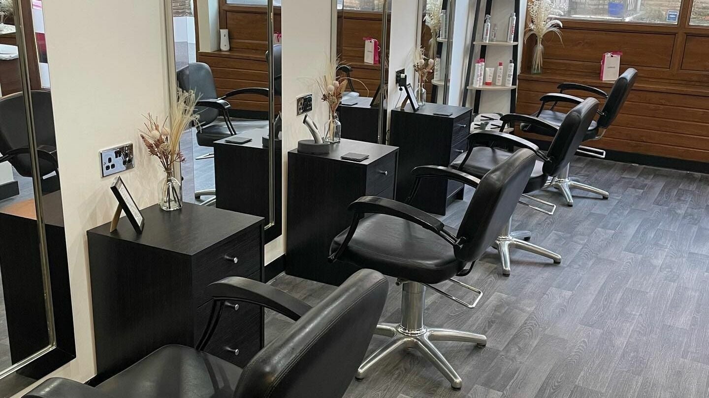 Modern styling area at Palmowski Hair Design in Wath upon Dearne, England, GB with sleek chairs and mirrors.