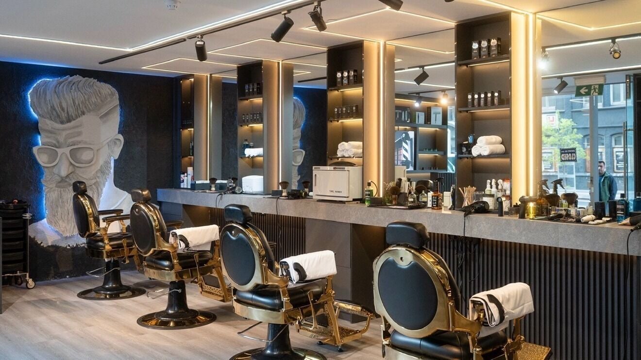 Modern interior of H50 Barbers in Southbank, Victoria, AU with chic barber chairs and illuminated decor.
