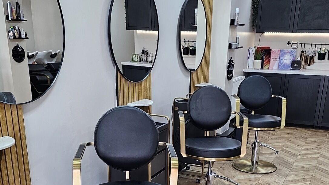 Modern salon at Bianca Simone Hair & Beauty, Prestatyn, Wales, GB, showcasing stylish chairs and mirrors.