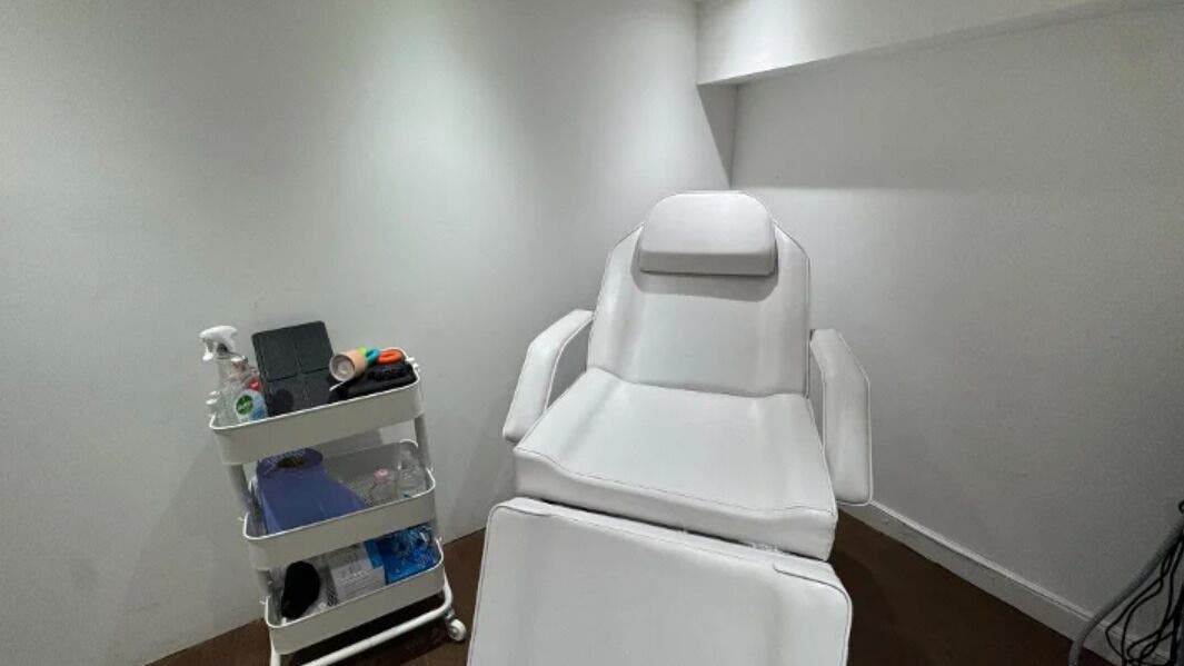Luxurious treatment room at Physioderma Clinic, London, England, GB, featuring a plush white chair and equipment.