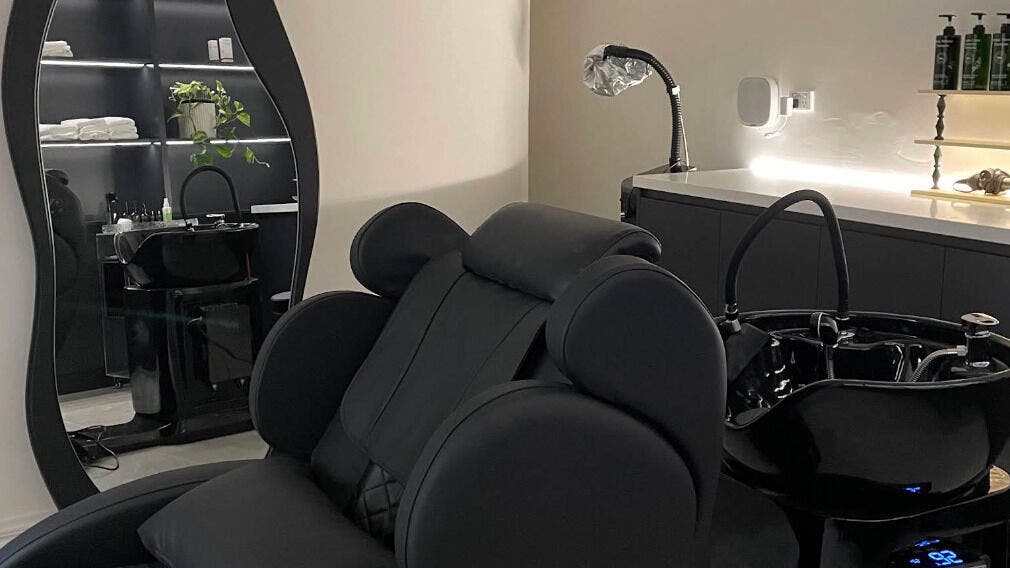 Elegant salon washing station at Chloe Cosmetique, Malvern, Victoria, AU, featuring modern decor and lighting.