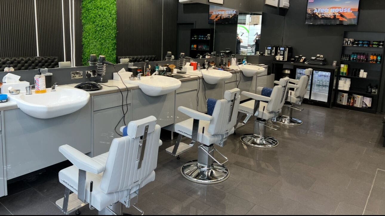 Spacious interior of Db Barbers - Tooting Bec, London, England, GB with modern barber chairs and sinks.