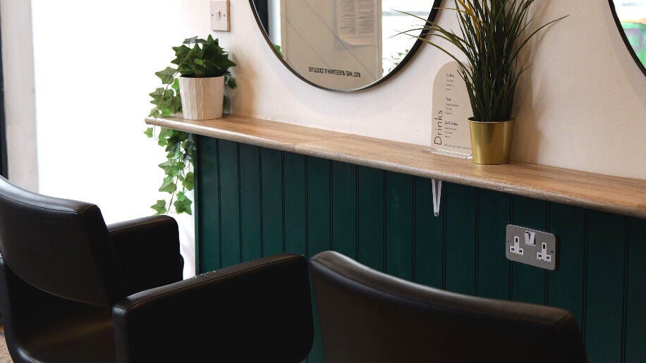 Stylish seating area at Studio Thirteen Salon in Tunbridge Wells, GB, with modern decor and plants.