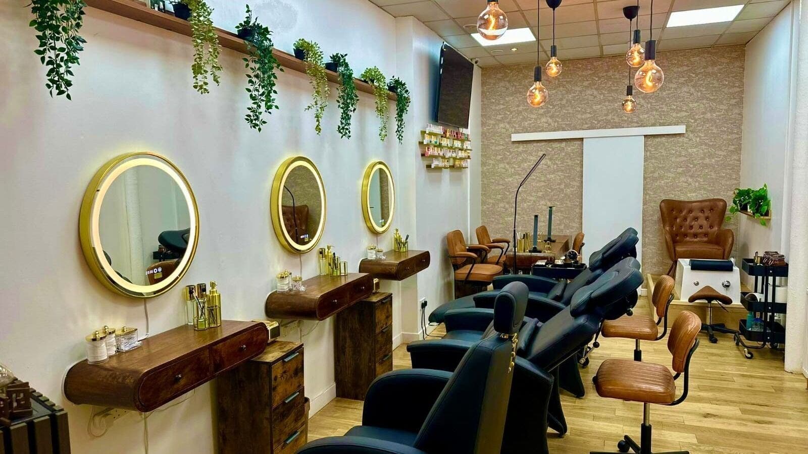 Modern salon interior at OPAL BEAUTY LTD, Glasgow, Scotland, GB with illuminated mirrors and chic styling chairs.