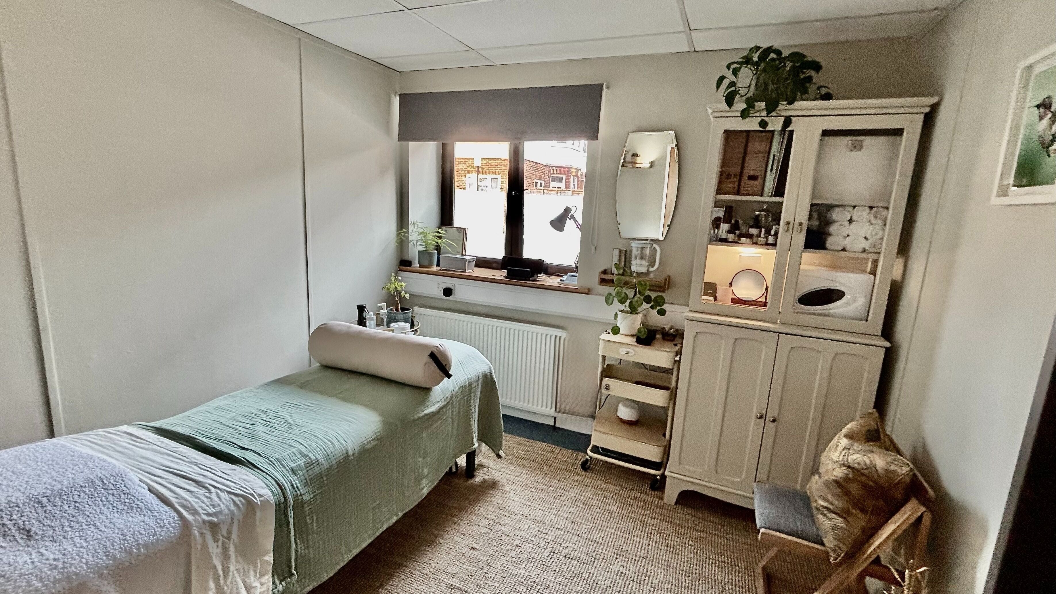 Calming therapy room at Burning Sage Reflexology, Brighton & Hove, England, GB featuring a cozy massage table.