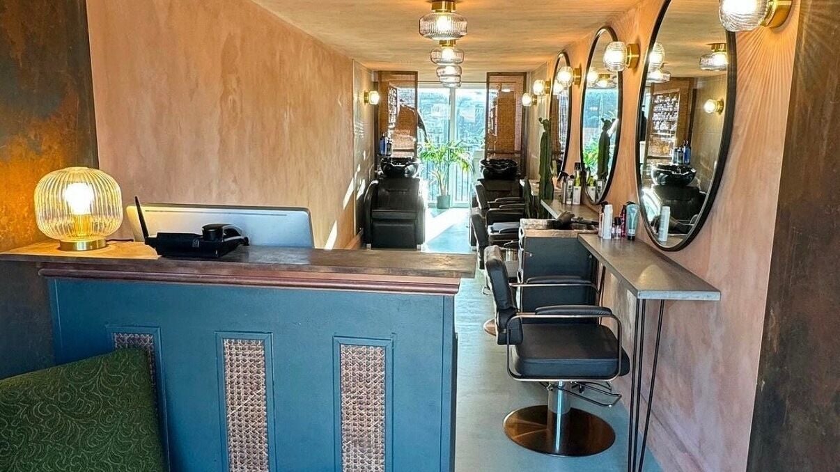 Cozy and elegant salon interior at Sher Arcana Studios, London, England, GB, featuring stylish decor and mirrors.