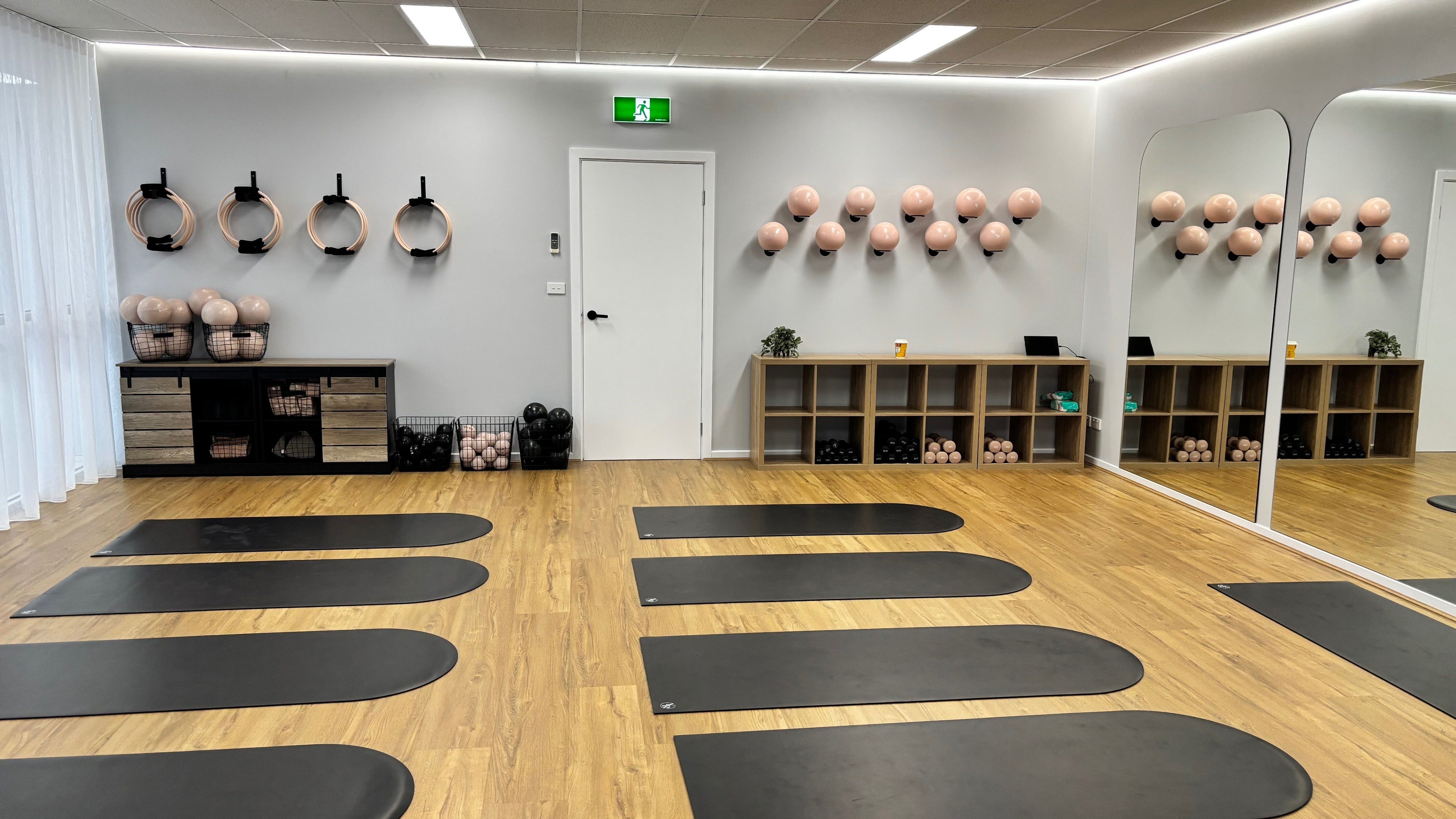 Spacious Pilates studio at Aspire Pilates, Melbourne, Victoria, AU featuring mats, mirrors, and wall-mounted equipment.
