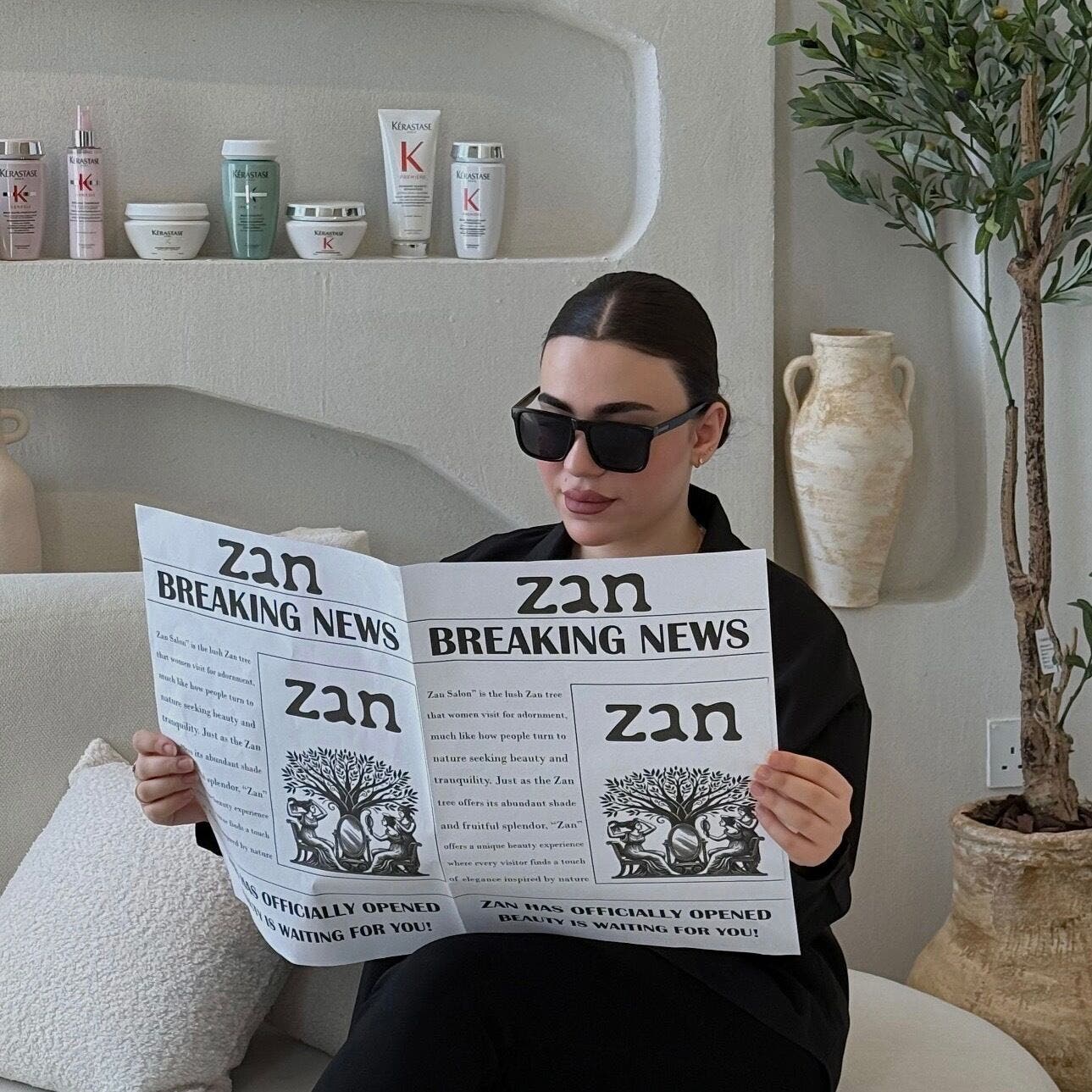 Woman reading at Zan Beauty | زان بيوتي, Riyadh, Riyadh Province, SA showcasing relaxation in a stylish setting.