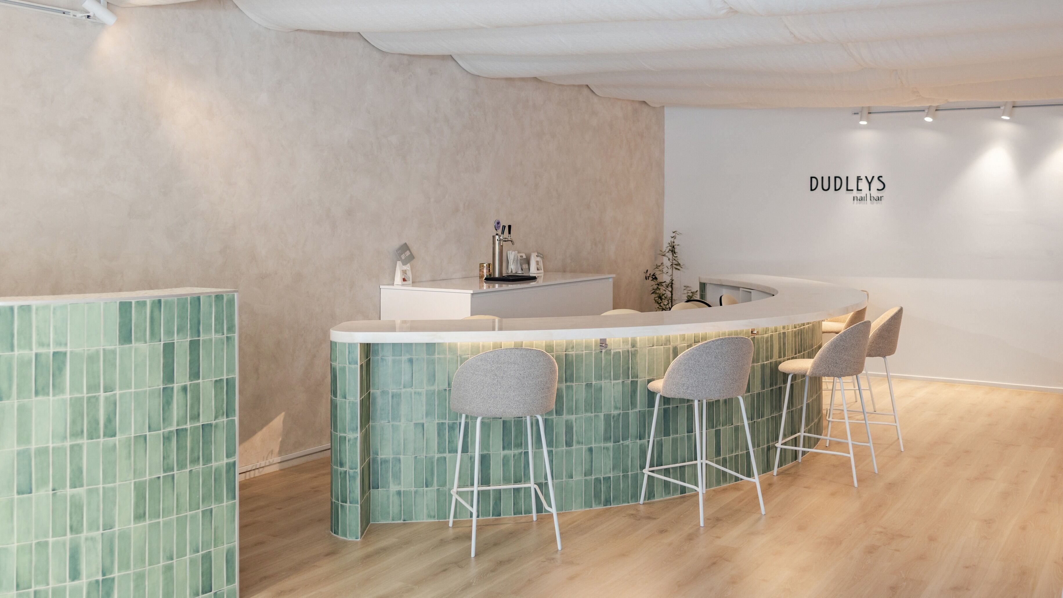 Modern Dudleys nail bar interior with stylish green counter in Auckland, Auckland, NZ.