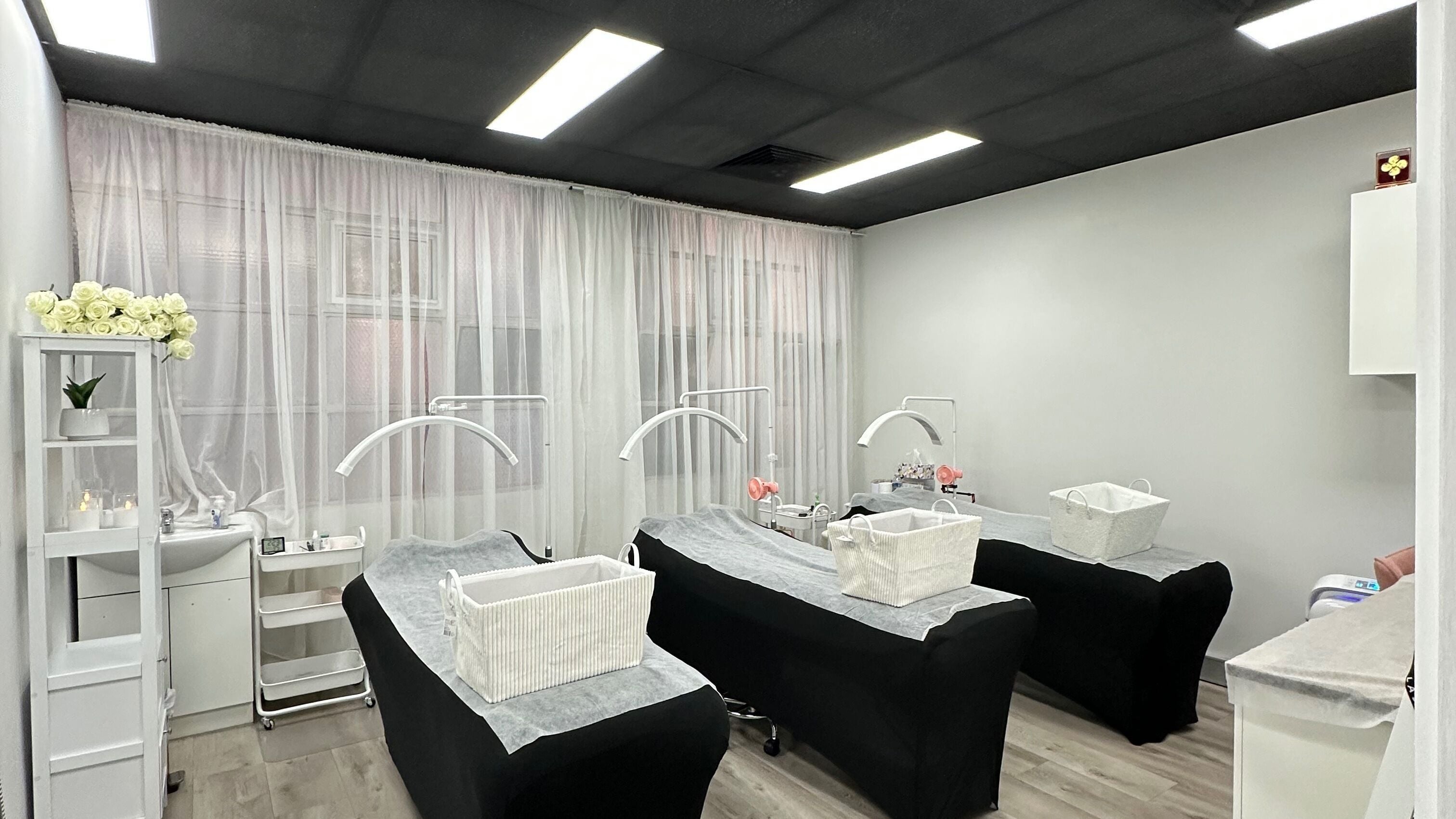 Elegant treatment room at Lash.PrettyUp, Melbourne, Victoria, AU, featuring three beds and ambient lighting.