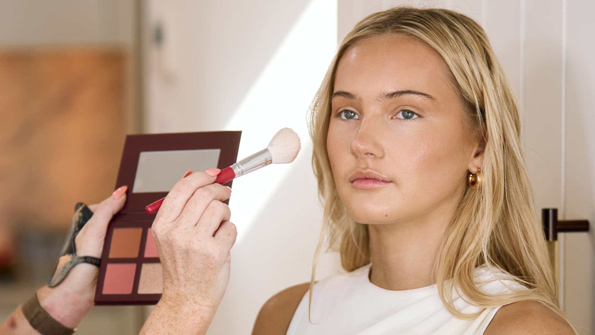 Makeup artist applying blush at Perth - South Coast, South of River & North of River, AU beauty venue.