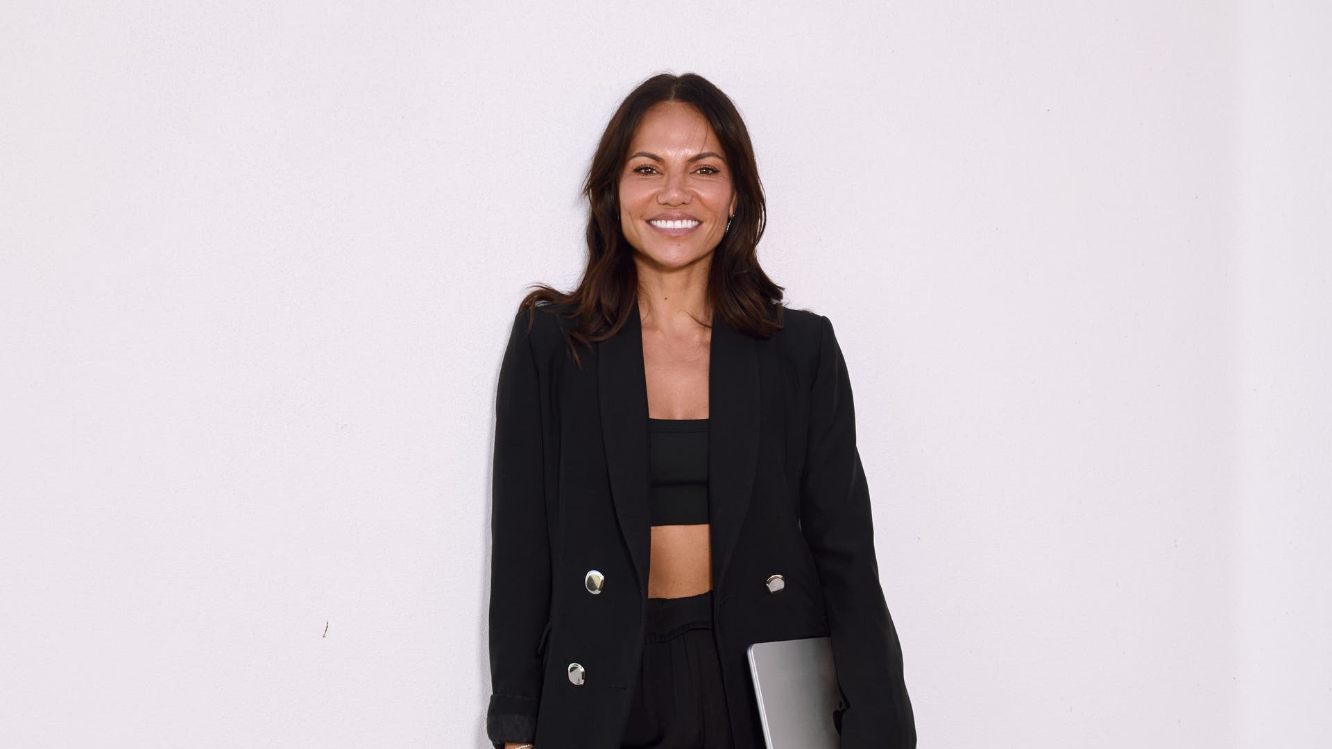 Confident woman in black blazer at Sydney - Northern Beaches, Manly, Dee Why, Brookvale, Narrabeen, Mona Vale, AU.