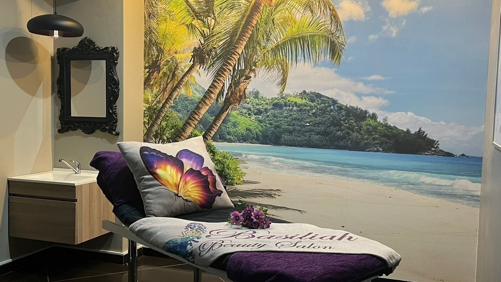 Relaxing spa room at Basiliah Beauty Salon, Pretoria, Gauteng, ZA featuring a tropical beach mural and plush decor.