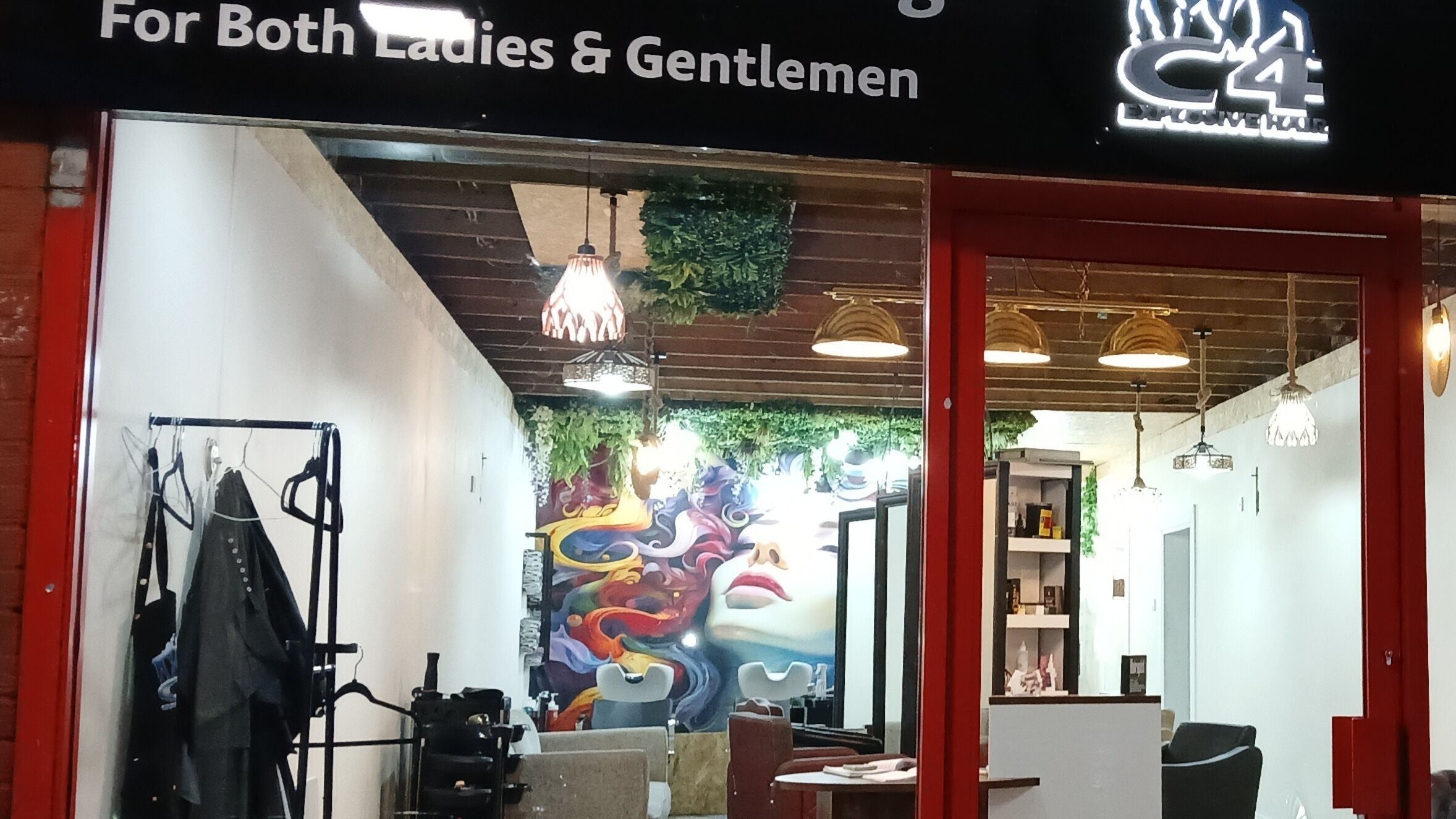 Interior view of Love Hair by Heather salon in Kirkintilloch, Scotland, GB with colorful mural and chic decor.