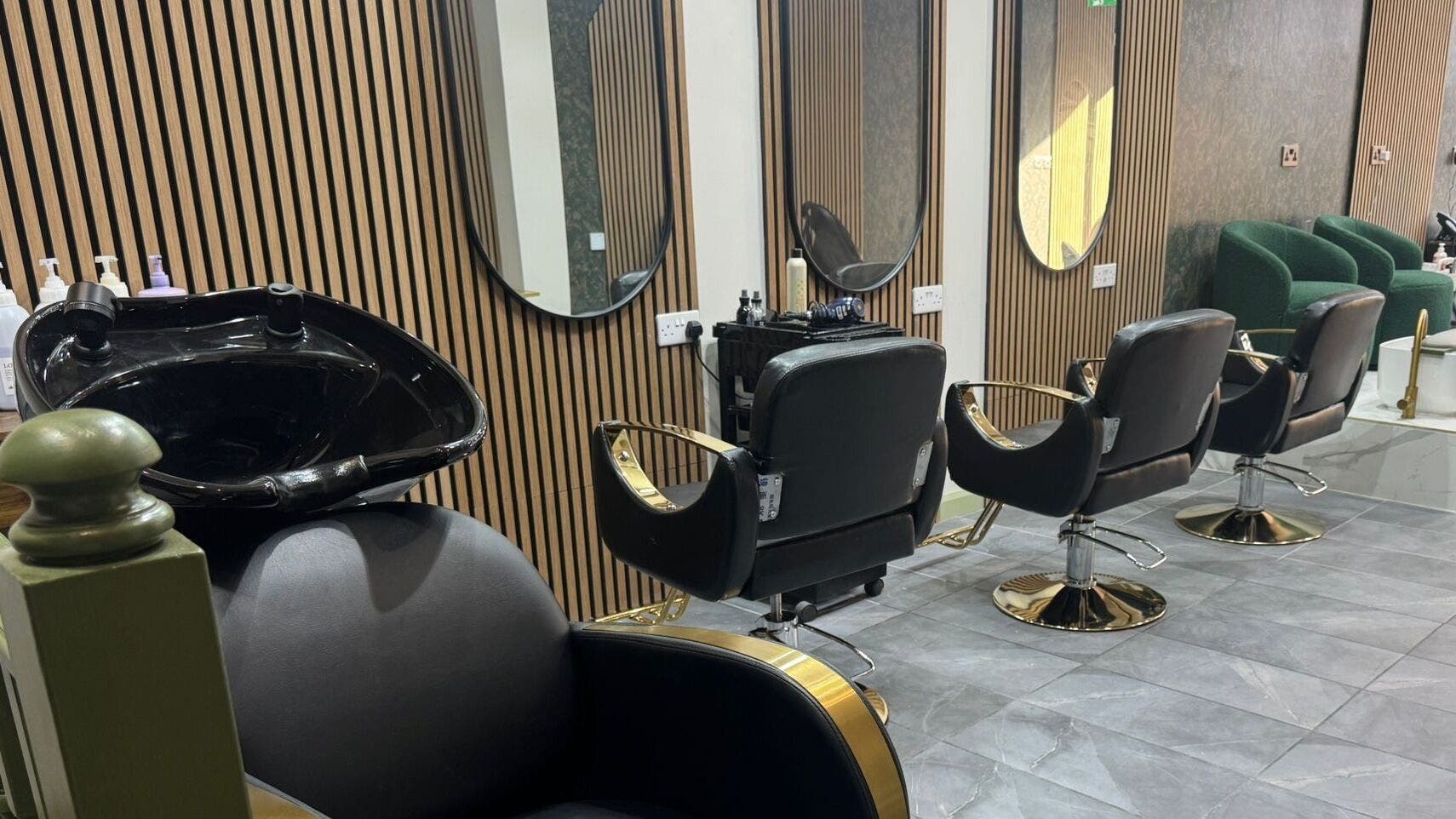 Modern salon chairs and mirrors at Maison De Gigi in London, England, GB, offering elegant beauty services.