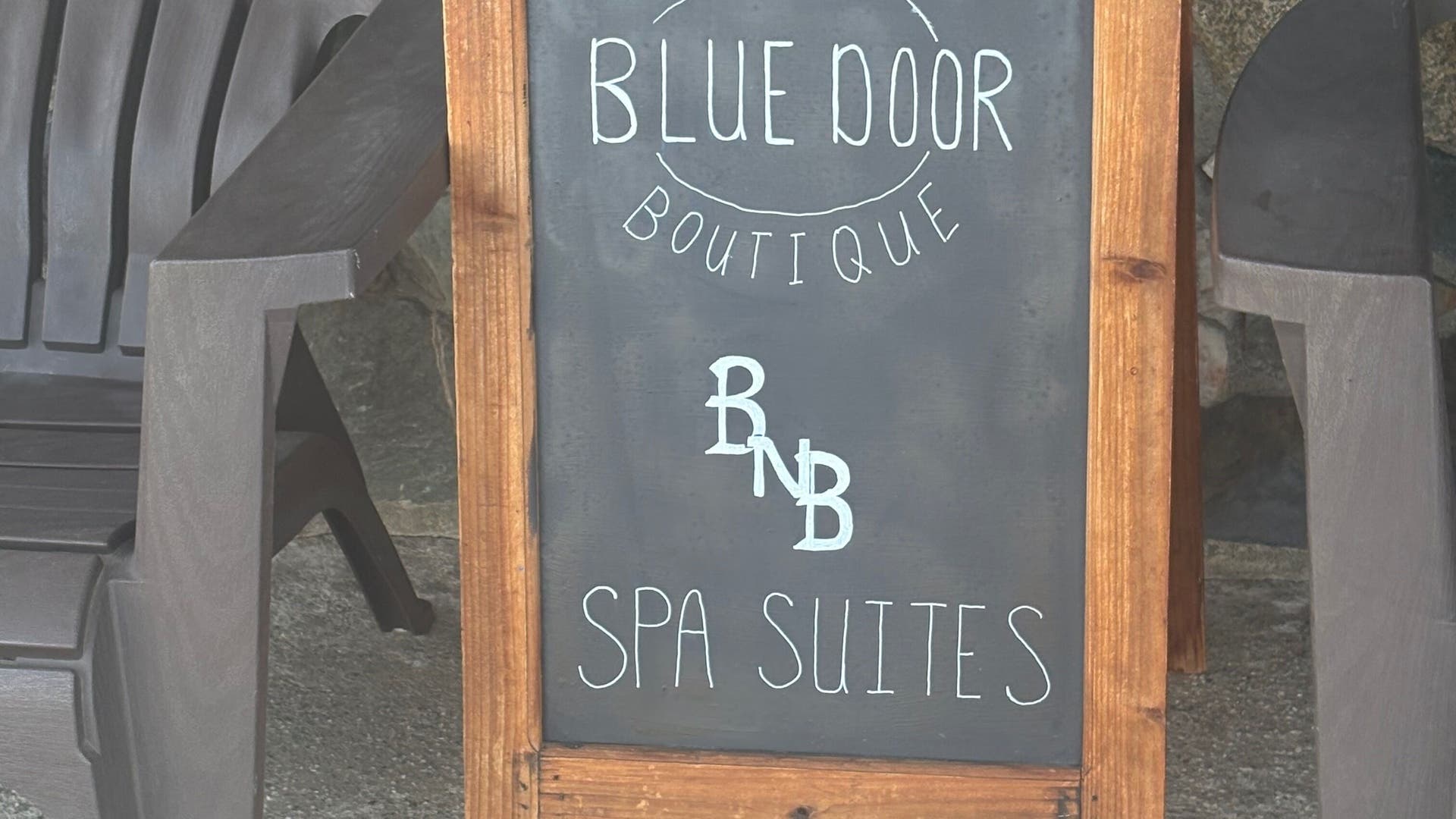 Blue Door Boutique spa sign near Glow Connection in Loomis, California, US offers serene spa suites.