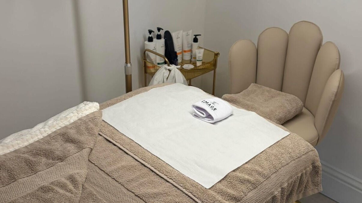 Tranquil treatment room at Skin by Gabriella in Barnet, England, GB featuring a plush bed and skincare products.