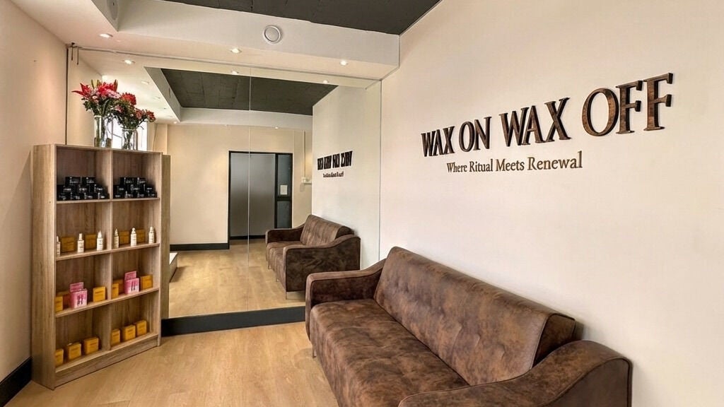 Cozy interior of Wax On Wax Off in Cape Town, Western Cape, ZA, featuring plush seating and elegant decor.