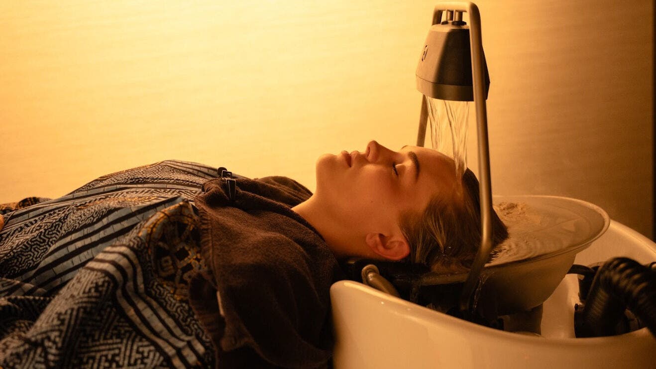 Relaxing head spa at Tokyo Headspa West End, West End, Queensland, AU. Woman enjoying soothing water treatment.