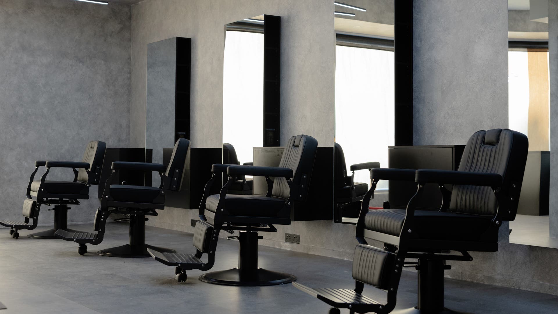 Luxurious salon chairs at Ellevate Hair Studio in Melbourne, Victoria, AU, offering comfort and style.
