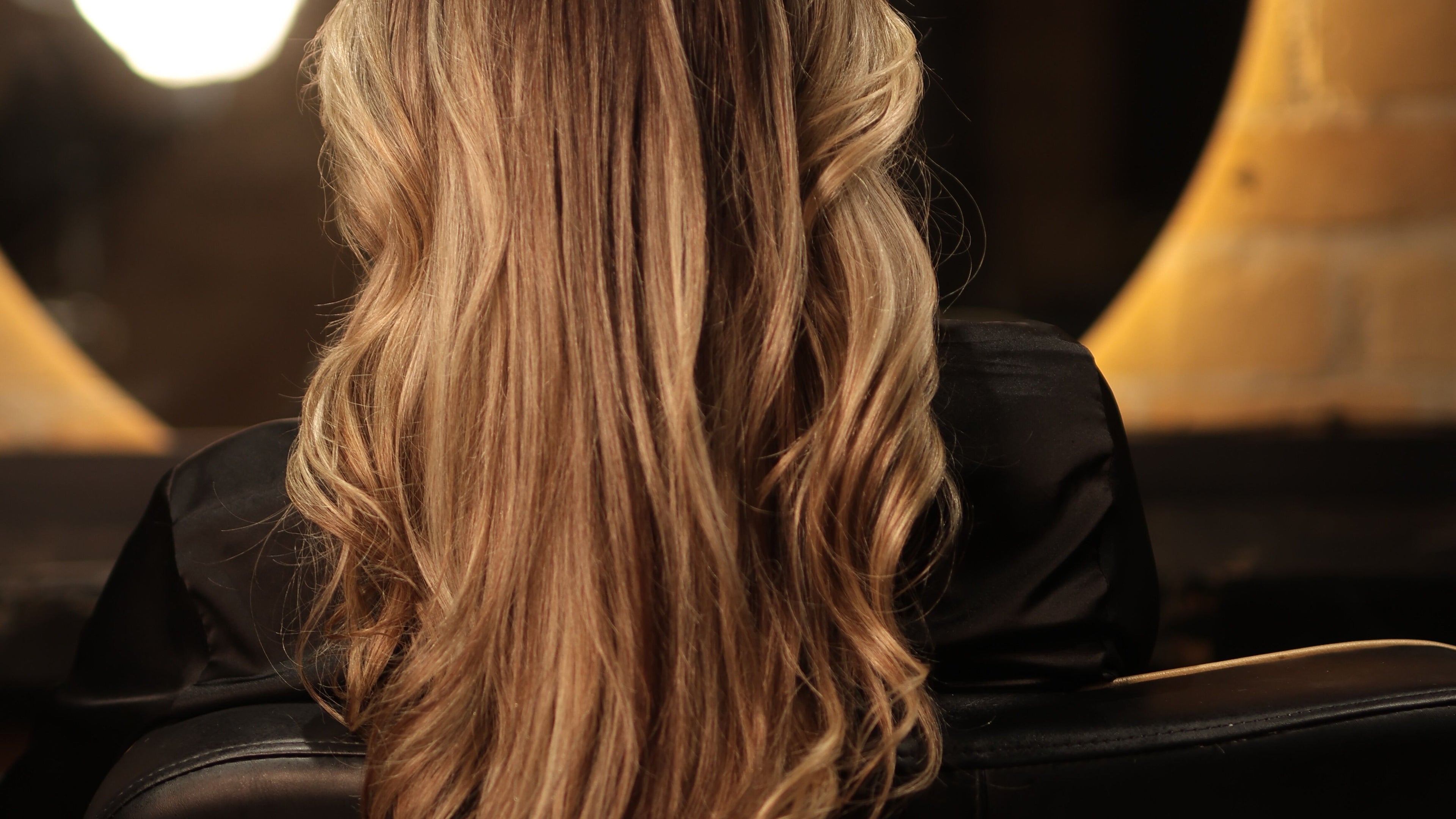 Stunning blonde hair styled at Enchante Salon, Auckland, Auckland, NZ, showcasing luxurious waves.