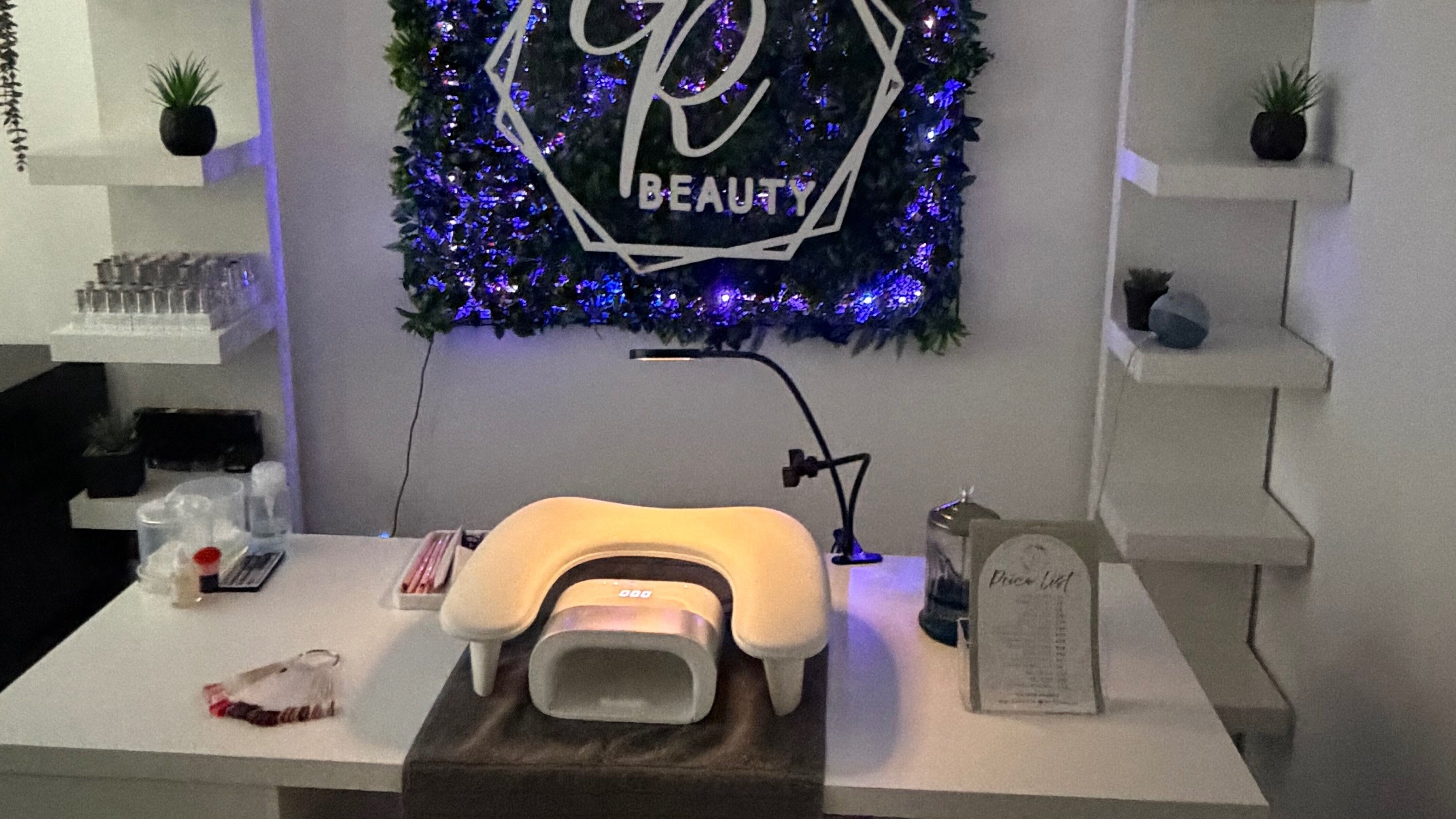 Elegant manicure station at GR Beauty, Egremont, England, GB with backlit decor and modern accents.
