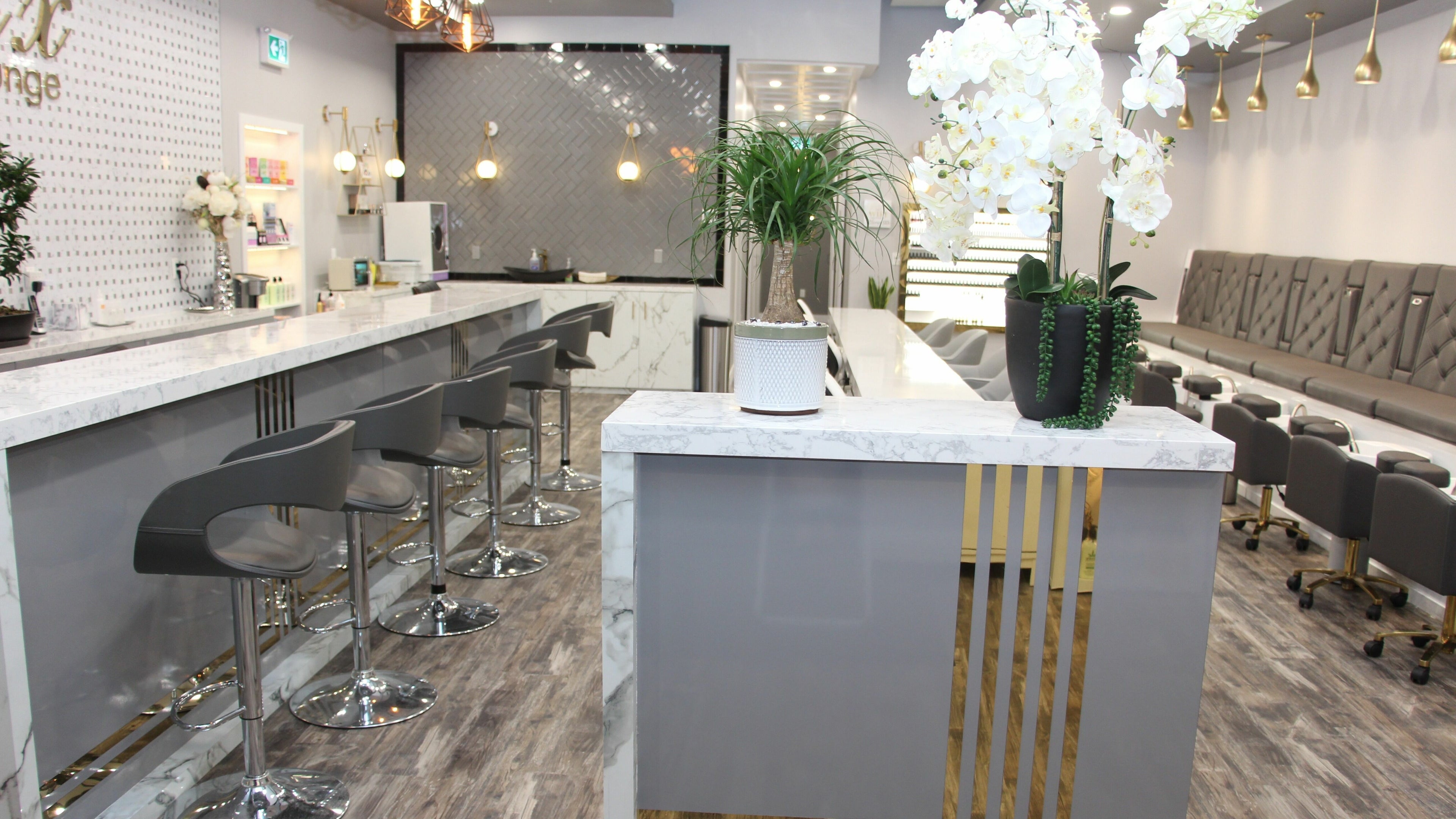 Sophisticated interior of MLux Spa & Nails Lounge in Red Deer, Alberta, CA with modern décor and seating.