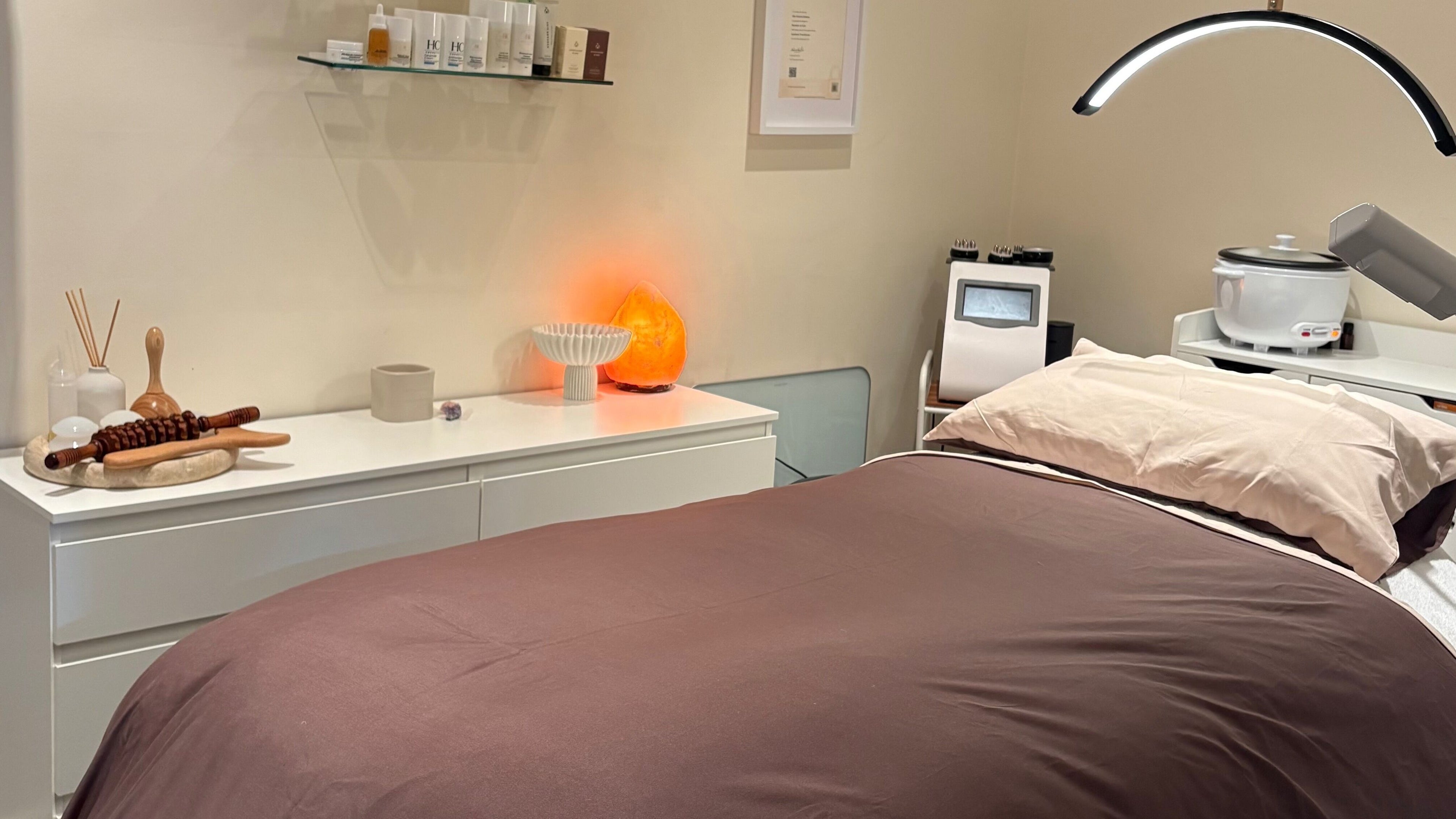 Peaceful spa treatment room at House of Cherub Skin, Melbourne, Victoria, AU with equipment and a cozy bed.